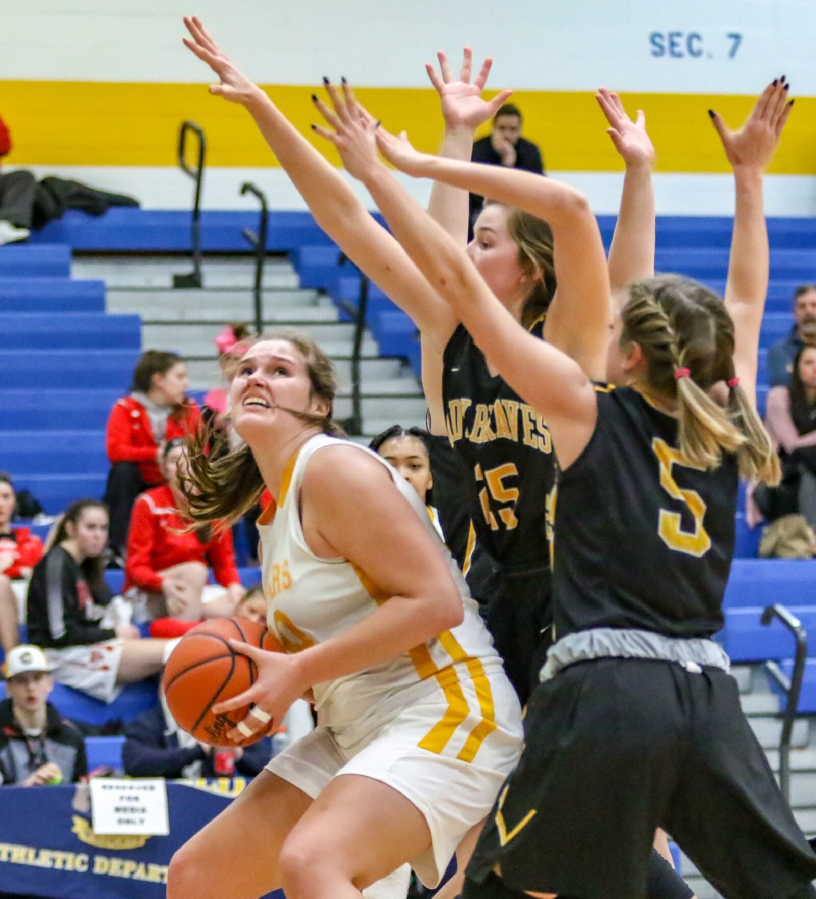 Kenton Ridge’s Mikala Morris is guarded by multiple Shawnee defenders during their D-II sectional game on Tuesday night at Springfield High School. The Cougars won 56-26. CONTRIBUTED PHOTO BY MICHAEL COOPER