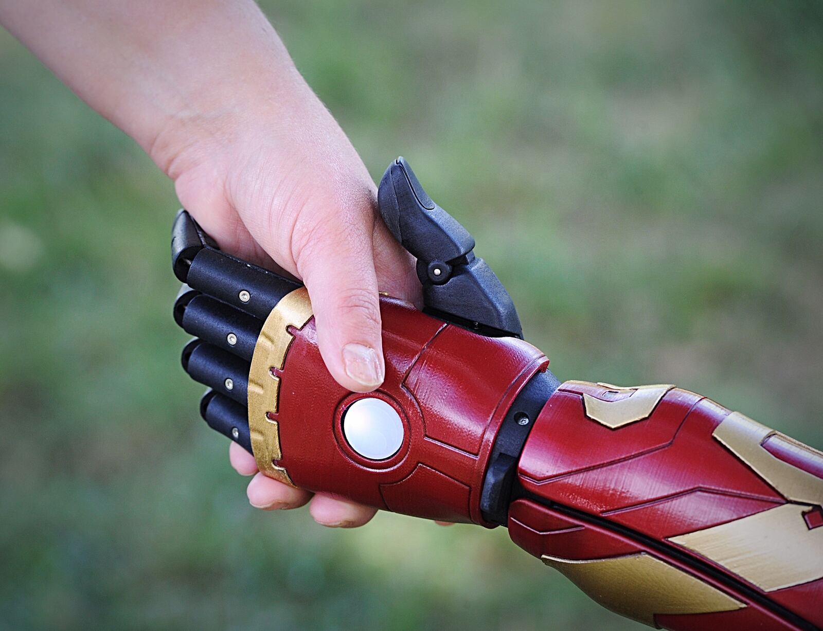 James Parris, age 8, shakes hands with his Iron Man prosthetic arm on Friday, Sept. 4, 2020. MARSHALL GORBY\STAFF