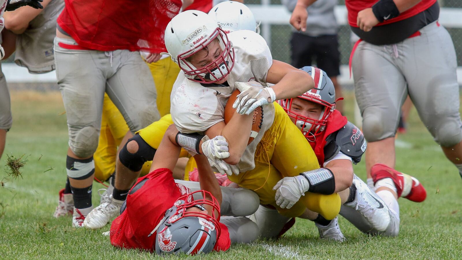 Northeastern High School freshman Gunnar Leonard is tackled by two Southeastern defenders during a five-team scrimmage on Saturday morning in South Charleston. CONTRIBUTED PHOTO BY MICHAEL COOPER