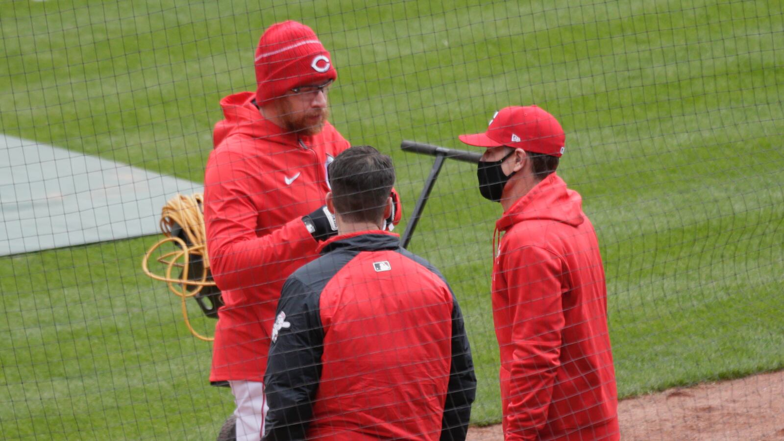 Reds manager David bell, right, talks to pitcher Sean Doolittle before Opening Day on Thursday, April 1, 2021, at Great American Ball Park in Cincinnati. David Jablonski/Staff