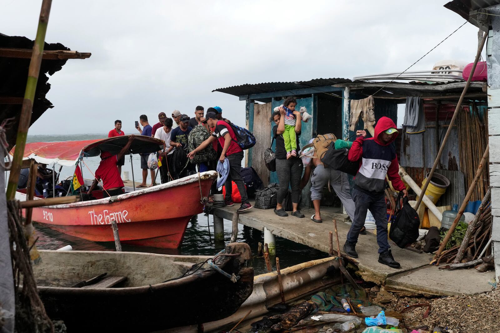 Venezuelan migrants arrive at Panama's Caribbean coastal island of in Gardi Sugdub, Sunday, Feb. 23, 2025, to board boats to Colombia after giving up hopes of reaching the U.S. while in southern Mexico as President Trump cracks down on migration. (AP Photo/Matias Delacroix)