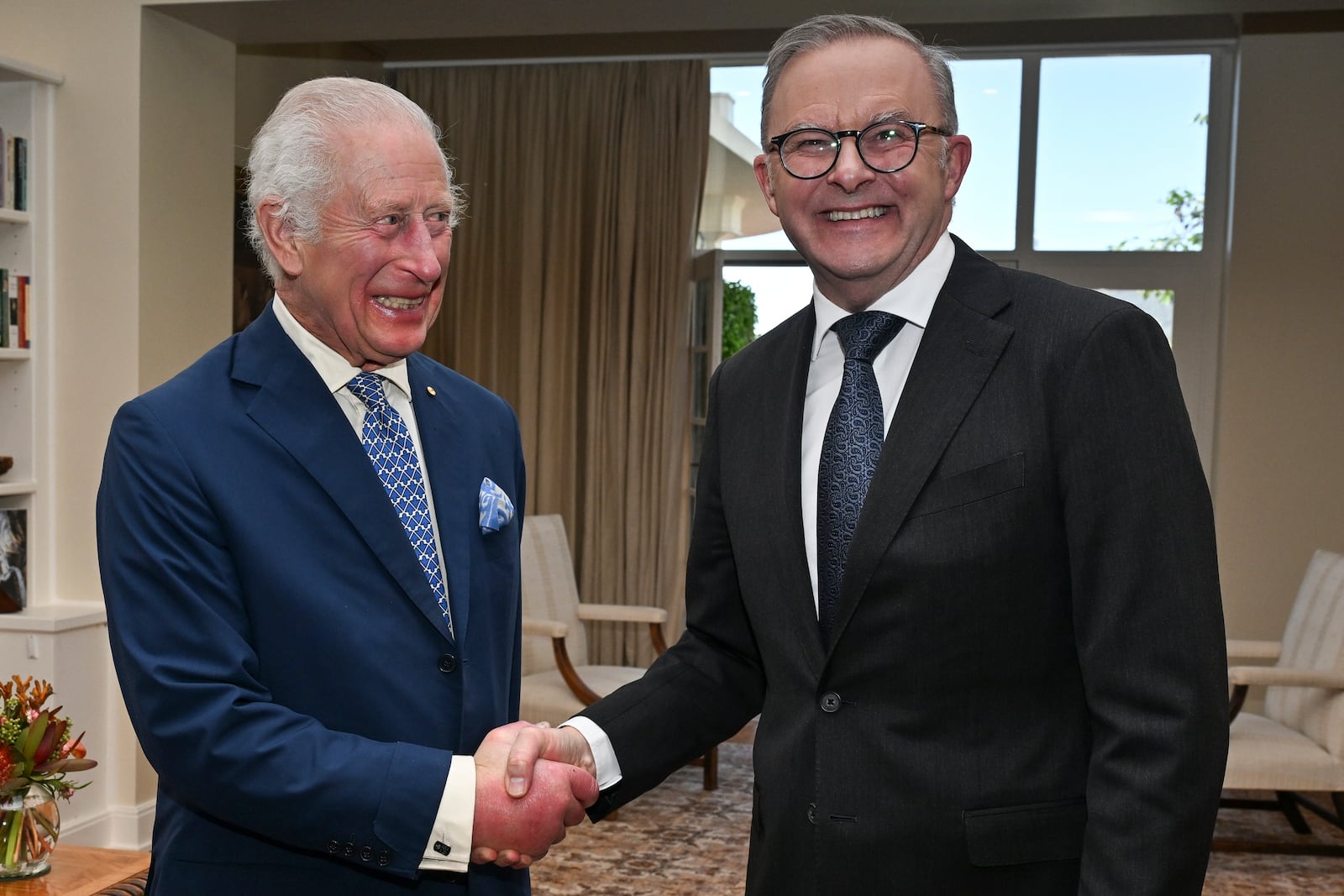 Britain's King Charles III shakes hands with Australia's Prime Minister Anthony Albanese, right, at Government House in Canberra, Australia, Monday, Oct. 21, 2024. (Saeed Khan/Pool Photo via AP)