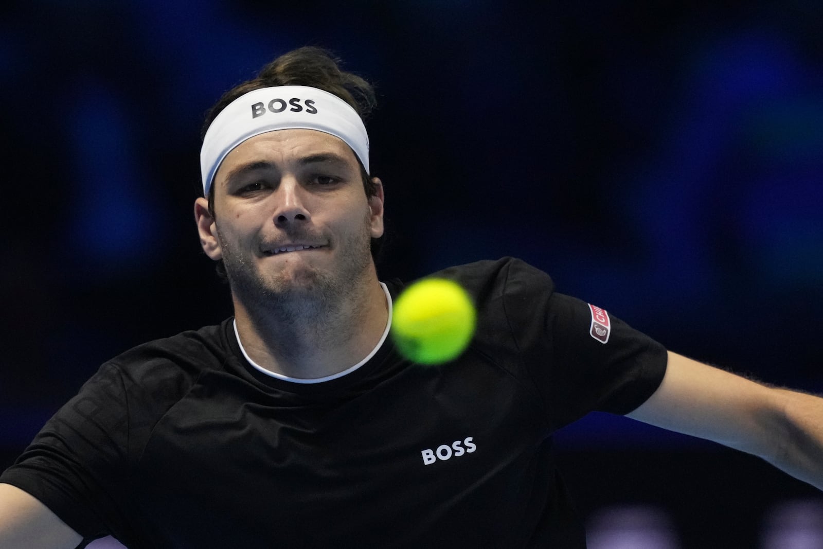 United States' Taylor Fritz returns the ball to Australia's Alex de Minaur during their singles tennis match of the ATP World Tour Finals at the Inalpi Arena, in Turin, Italy, Thursday, Nov. 14, 2024. (AP Photo/Antonio Calanni)