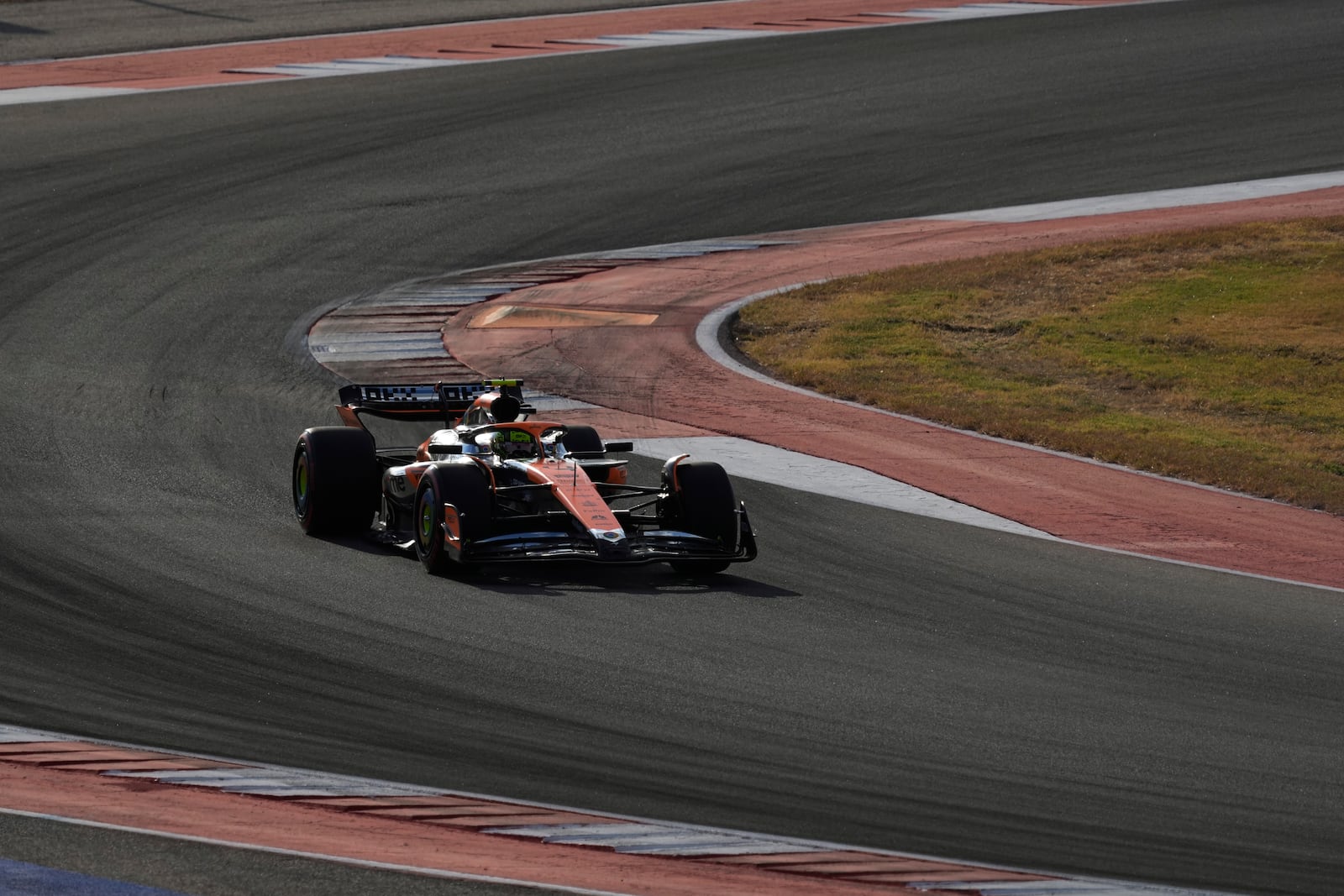 McLaren driver Lando Norris, of Britain, steers through a turn during a qualifying session for the Formula One U.S. Grand Prix auto race at Circuit of the Americas, Saturday, Oct. 19, 2024, in Austin, Texas. (AP Photo/Eric Gay)