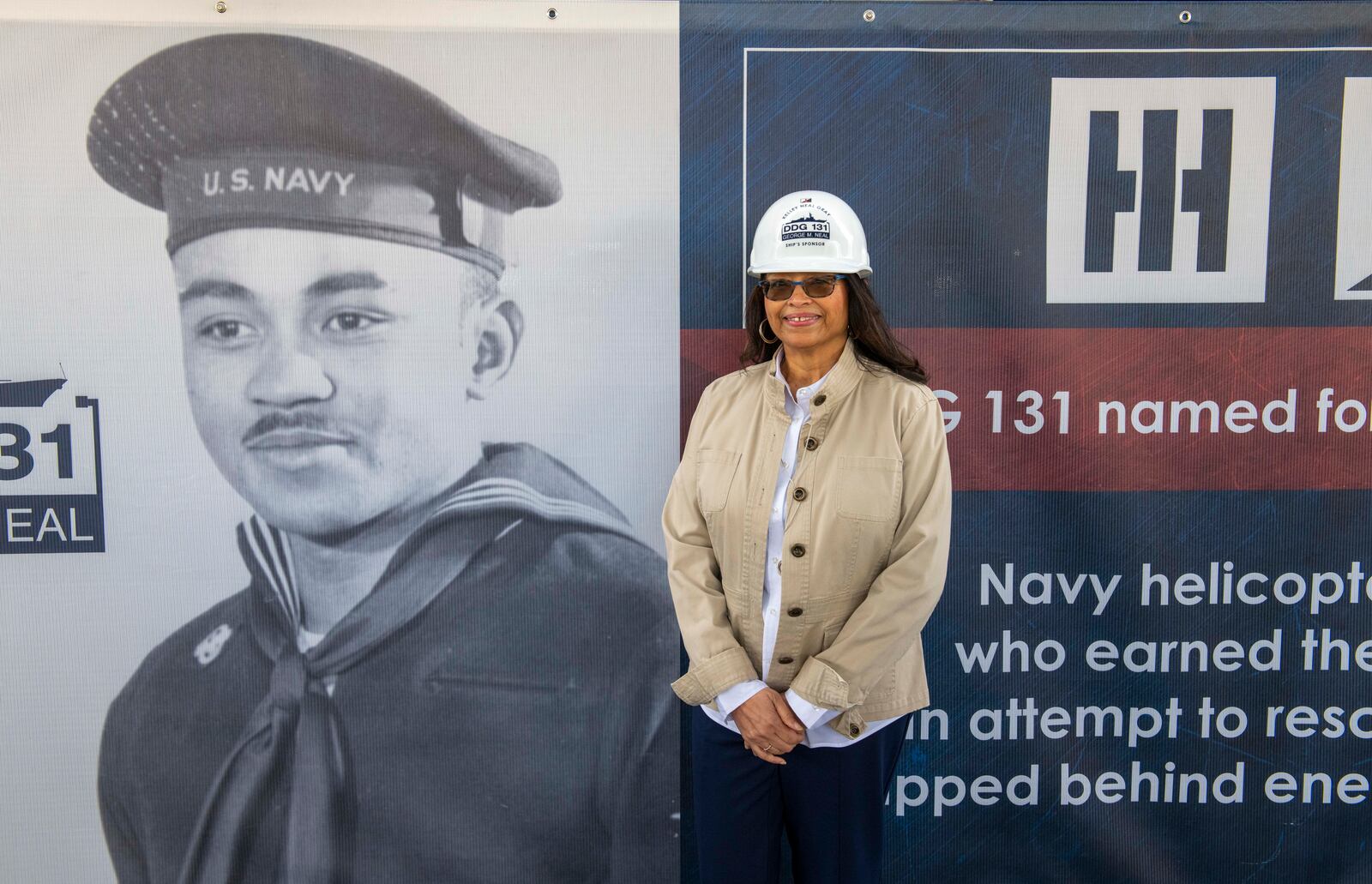 Kelley Elaine Neal Gray next to a picture of her late father at the Dec. 15 keel authentication ceremony for the Navy battleship that will be named for him. CONTRIBUTED