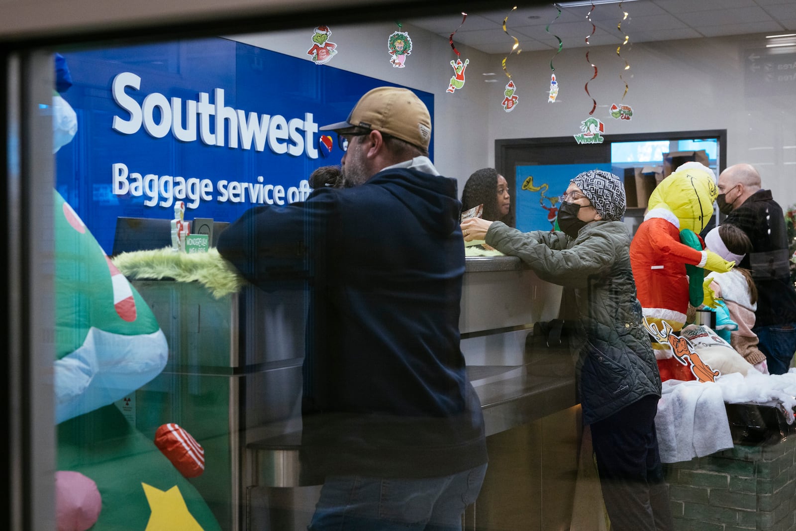 Travelers wait in line for Southwest Airlines baggage services at Midway International Airport in Chicago, on Tuesday, Dec. 27, 2022. Southwest Airlines has already called off more than 60 percent of its flights for the day. (Taylor Glascock/The New York Times)