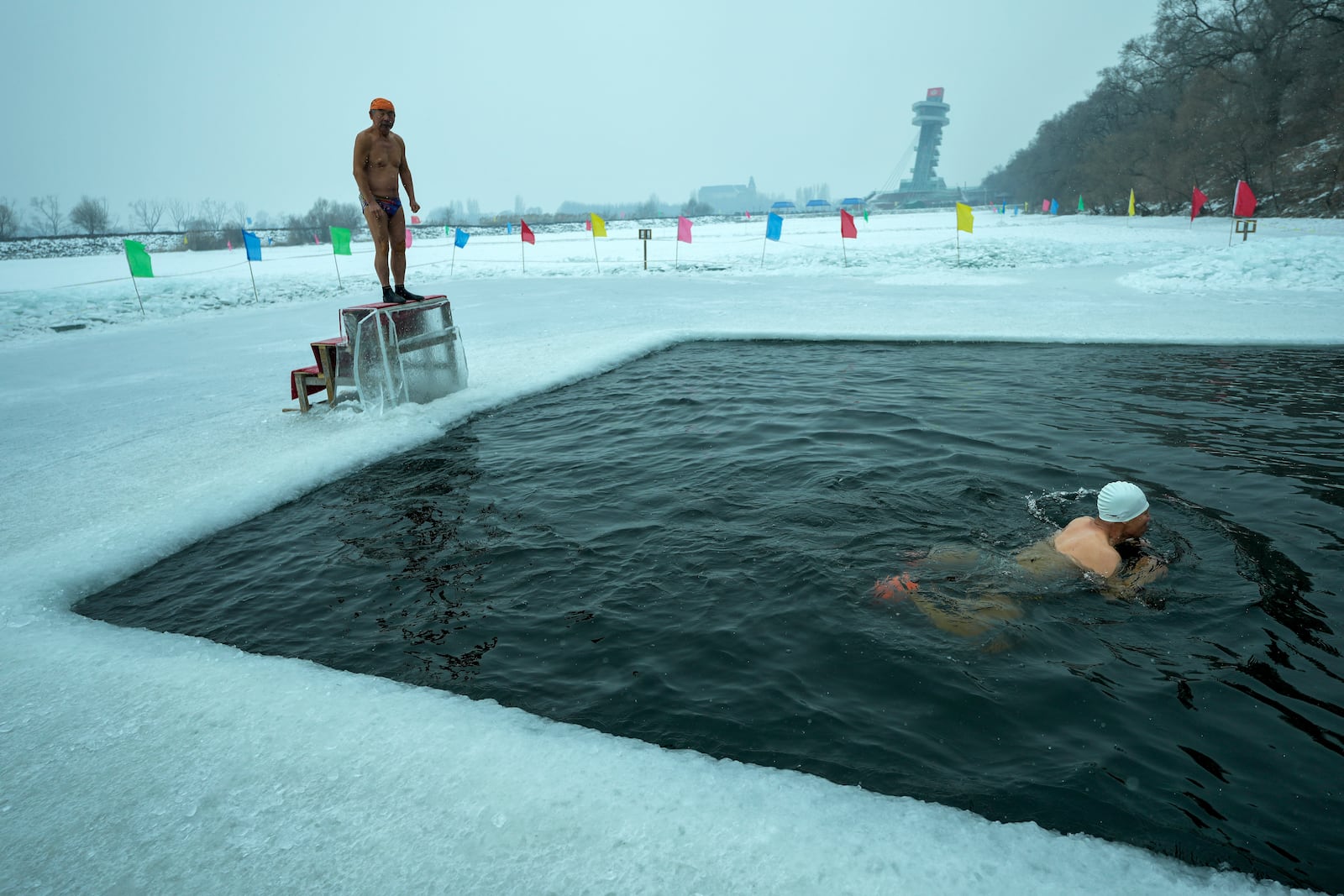 Residents swim in a pool carved from ice on the frozen Songhua river in Harbin in northeastern China's Heilongjiang province, Tuesday, Jan. 7, 2025. (AP Photo/Andy Wong)