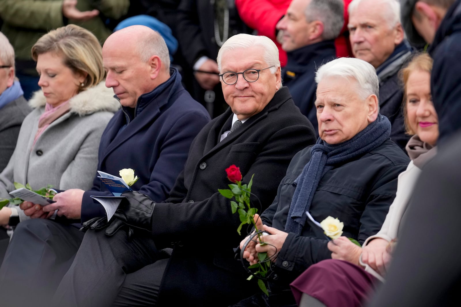 German President Frank-Walter Steinmeier, centre, attends a flower laying ceremony on occasion of the 35th wall anniversary at the grounds of the Berlin Wall Memorial, Berlin, Germany, Saturday, Nov.9, 2024. (AP Photo/Ebrahim Noroozi)