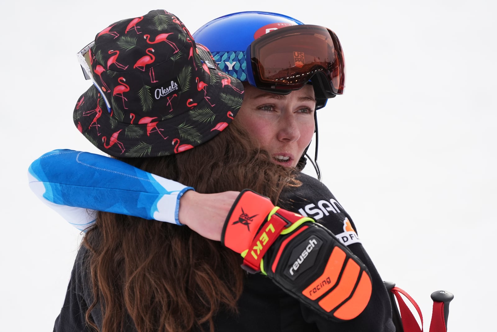 United States' Mikaela Shiffrin, right, hugs United States' Lauren Macuga at the finish area of a slalom run of a women's team combined event, at the Alpine Ski World Championships, in Saalbach-Hinterglemm, Austria, Tuesday, Feb. 11, 2025. (AP Photo/Giovanni Auletta)