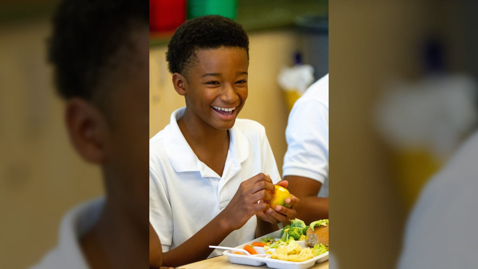 Drew Charter School student Isaiah Rashid peals an orange while eating a school lunch Friday, Aug. 9, 2019.