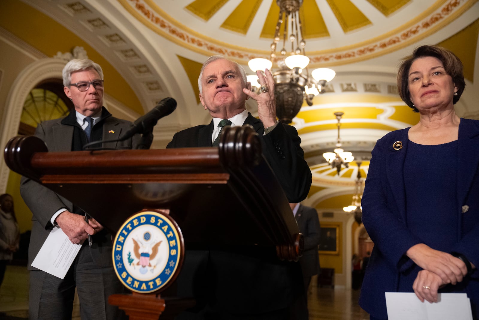 Sen. Jack Reed, D-R.I., center, is flanked by Sen. Sheldon Whitehouse, D-R.I., left, and Sen. Amy Klobuchar, D-Minn., right, as he speaks to reporters about President-elect Donald Trump's pick for Secretary of Defense, Pete Hegseth, on Capitol Hill, Tuesday, Jan. 14, 2025, in Washington. (AP Photo/Mark Schiefelbein)