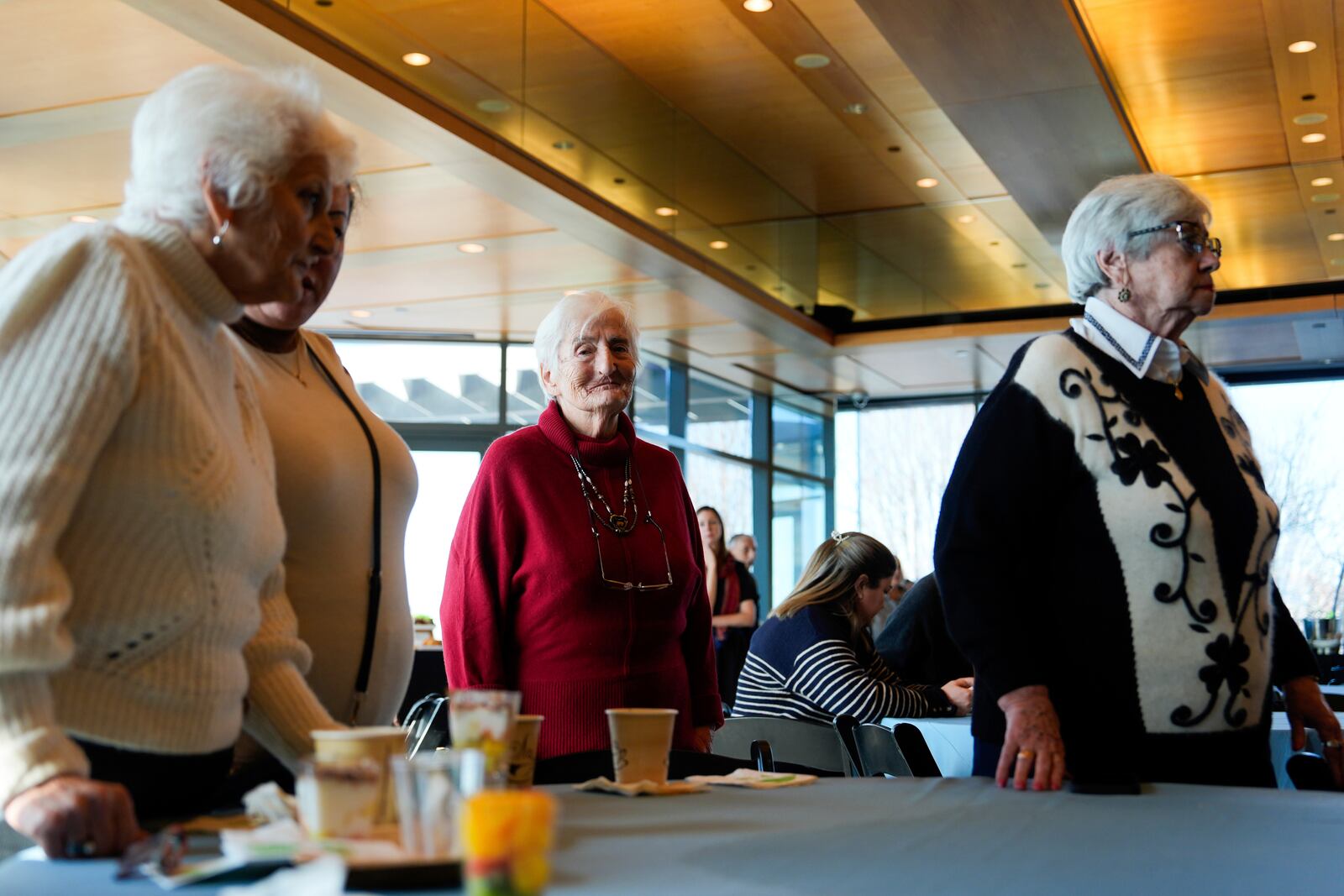 Holocaust survivors stand during a moment of silence during an International Holocaust Remembrance Day event at the Museum of Jewish Heritage, Monday, Jan. 27, 2025, in New York. (AP Photo/Julia Demaree Nikhinson)