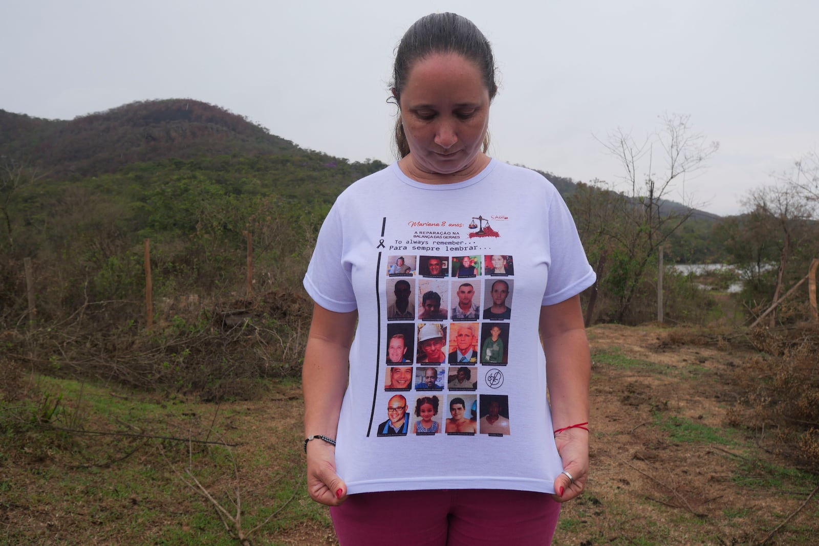 Monica dos Santos, 39, wears a T-shirt with the photos of victims of a dam break in Bento Rodrigues, Minas Gerais state, Brazil, Oct. 19, 2024. Victims of Brazil’s worst environmental disaster, on Nov. 5, 2015, took their case for compensation to a UK court on Monday, Oct. 21, 2024, almost nine years after tons of toxic mining waste poured into a major waterway, killing 19 people and devastating local communities. (AP Photo/Eleonore Hughes)