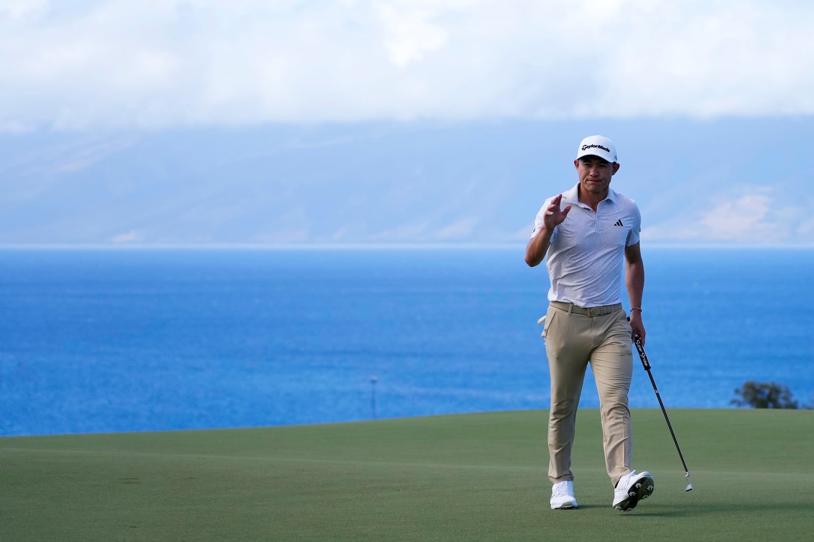 Collin Morikawa waves to the gallery after making a birdie putt at the 10th hole during the second round of The Sentry golf event, Friday, Jan. 3, 2025, at the Kapalua Plantation Course in Kapalua, Hawaii. (AP Photo/Matt York)