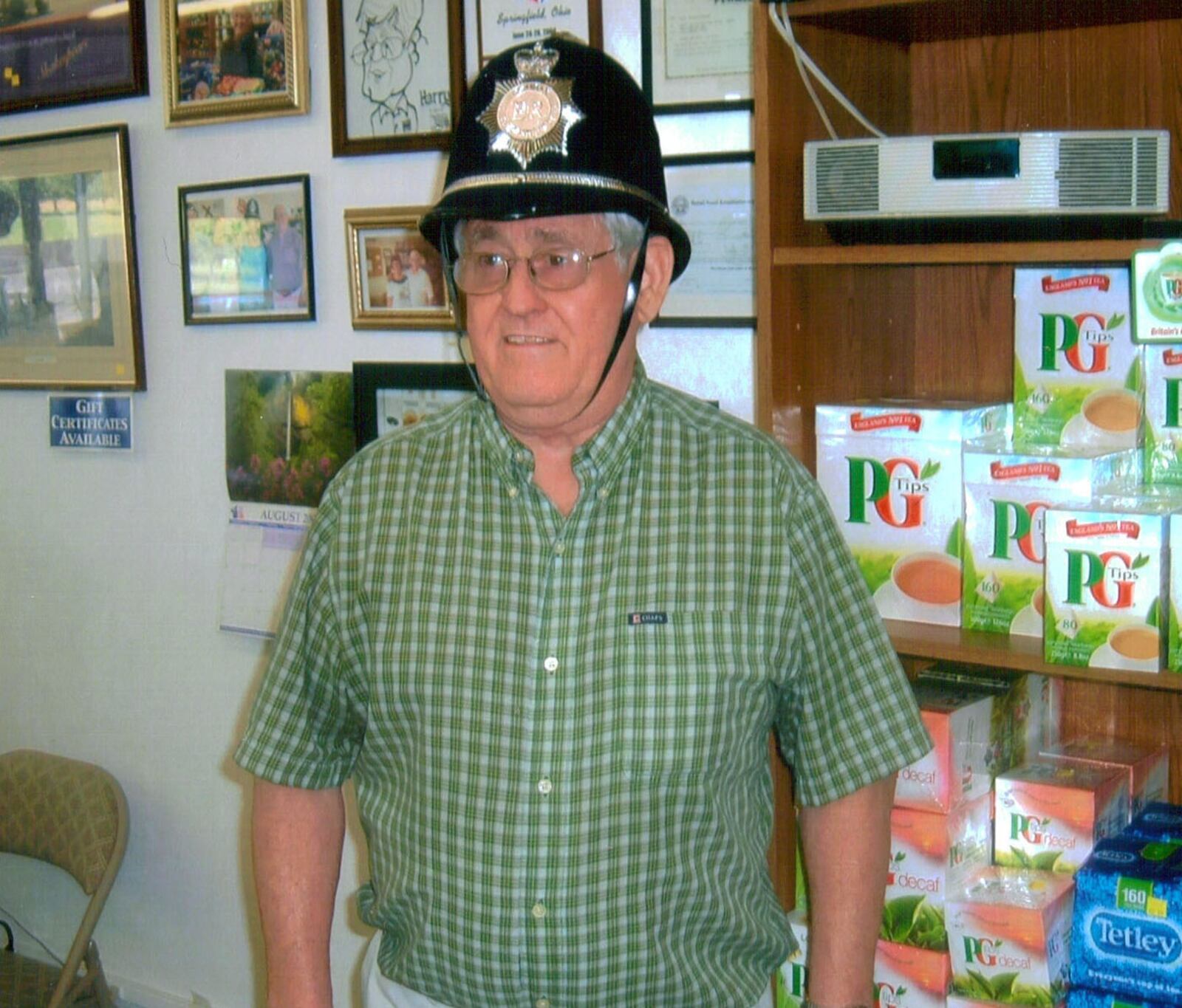 Harry Caswell dons British store trademark, a bobbie helmet