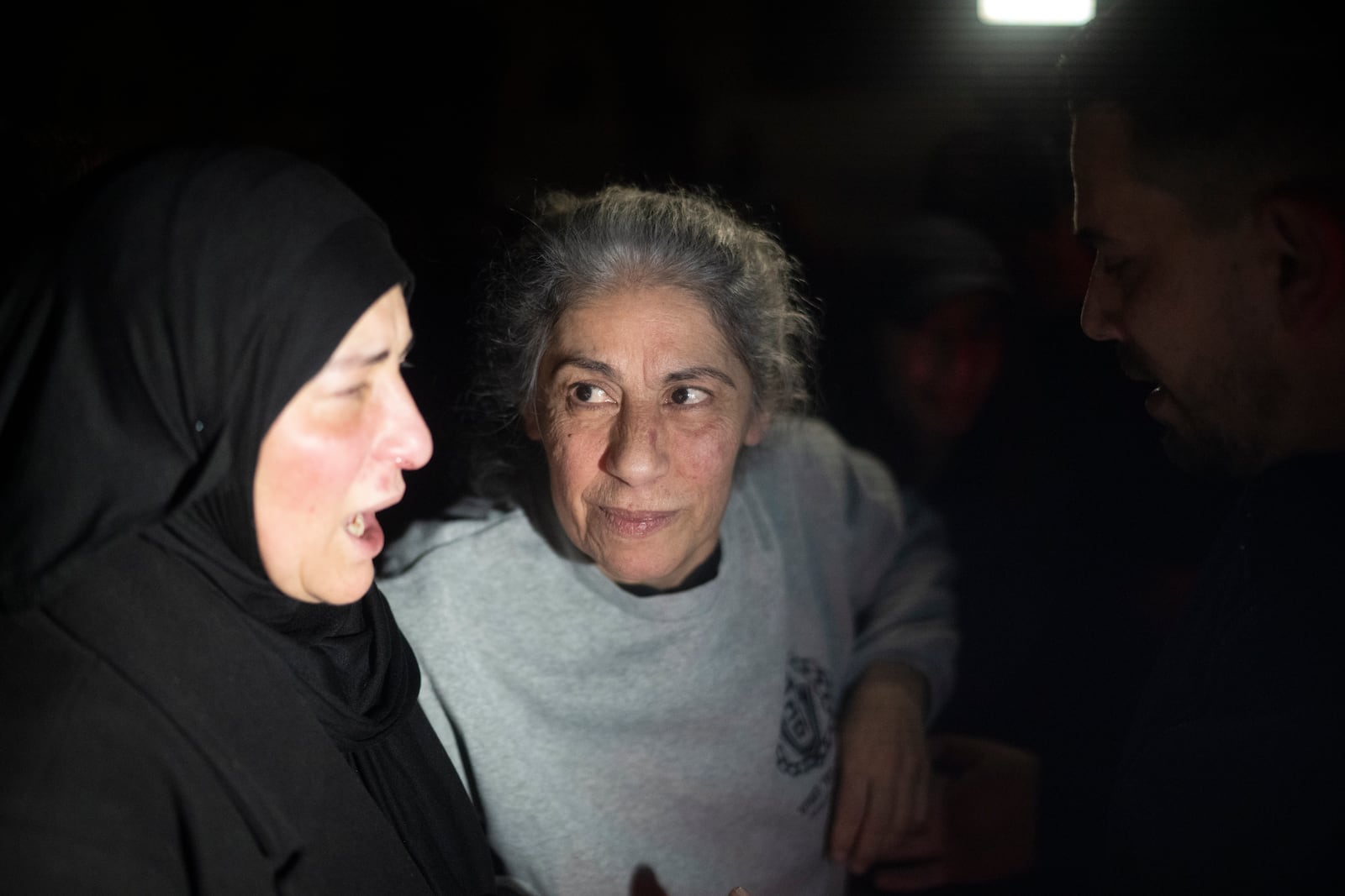 Khalida Jarrar, 62, a leading member of the Popular Front for the Liberation of Palestine, is greeted after disembarking from a bus following her release from an Israeli prison, in the West Bank city of Beitunia, early Monday, Jan. 20, 2025. (AP Photo/Leo Correa)