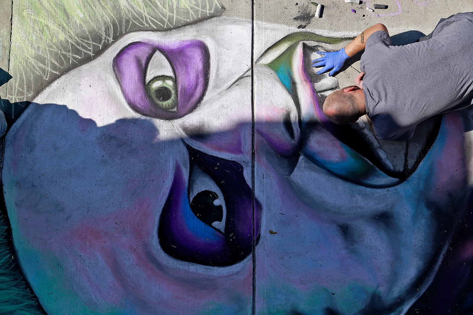 Gary Wade works on his chalk art Saturday, Oct. 5, 2024 during ChalkFest at National Road Commons Park in downtown Springfield. Dozens of amateur and professional artists from around the area showed off their skill on the sidewalks and streets around the park. ChalkFest also featured live music, food trucks and creative activities for the kids. BILL LACKEY/STAFF