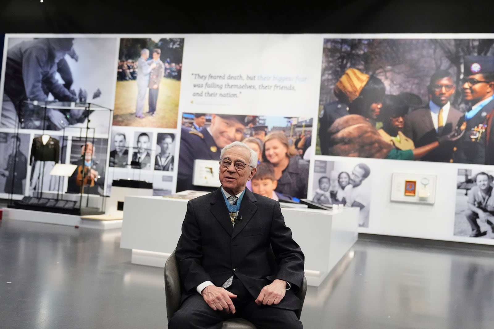 Jack Jacobs, a retired U.S. Army colonel who was awarded the Medal of Honor for his actions during the Vietnam War, responds to a question as he sits inside the National Medal of Honor Museum in Arlington, Texas, Thursday, March 13, 2025. (AP Photo/Tony Gutierrez)