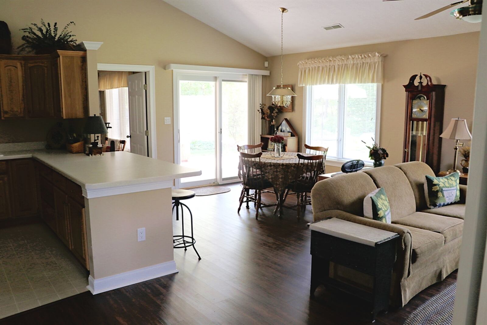 A wide peninsula counter divides the dining area from the spacious kitchen and offers breakfast bar seating.