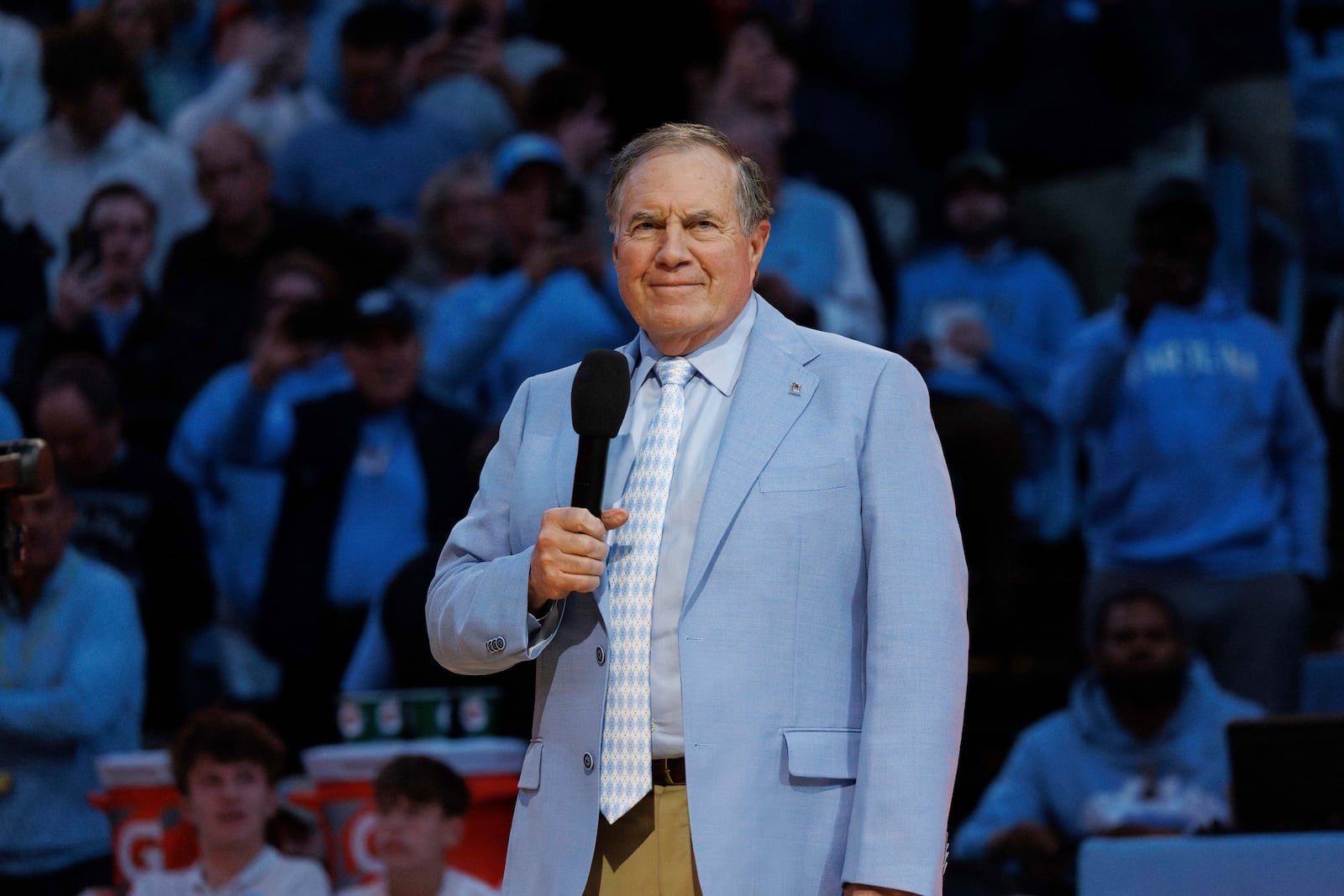 New North Carolina head football coach Bill Belichick speaks to the crowd at Dean Smith Center during halftime of an NCAA college basketball game between La Salle and North Carolina in Chapel Hill, N.C., Saturday, Dec. 14, 2024. (AP Photo/Ben McKeown)