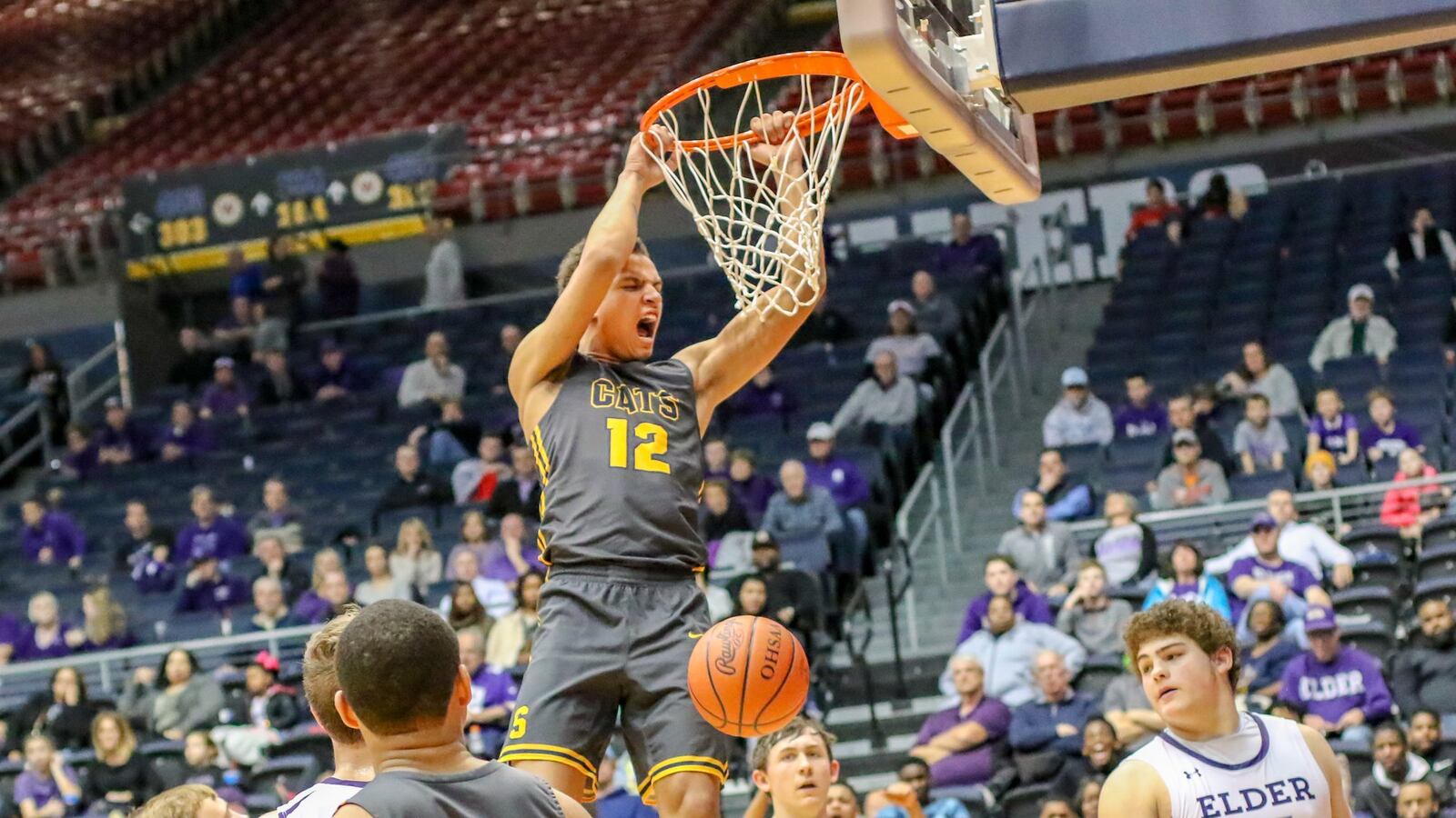 Springfield High School junior Raymans Cole finishes off a dunk during their Division I district final game against Elder on Saturday night at the University of Dayton Arena. The Wildcats won 55-35. CONTRIBUTED PHOTO BY MICHAEL COOPER