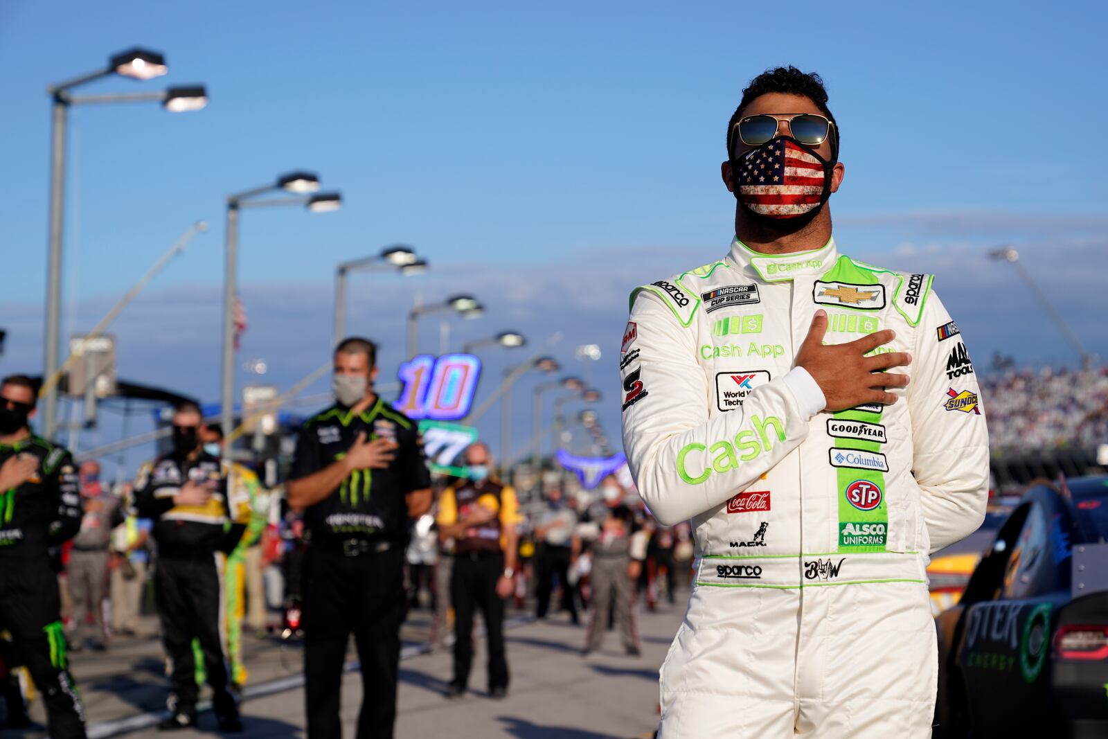 Bubba Wallace participates in the national anthem before a NASCAR Cup Series auto race Sunday, Sept. 6, 2020, in Darlington, S.C. (AP Photo/Chris Carlson)