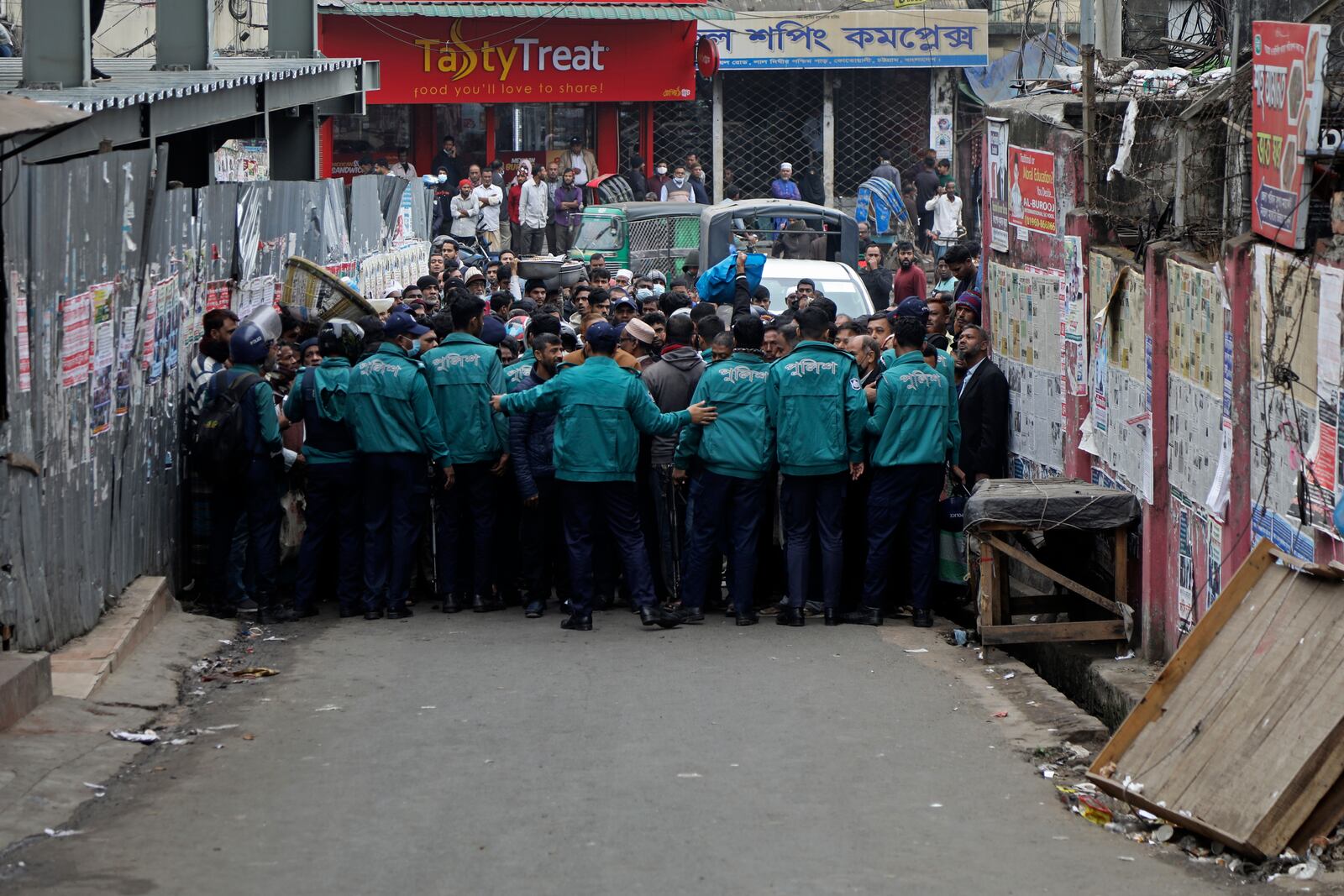 Police officials block a street leading to the court during the hearing of the bail plea by Krishna Das Prabhu, a jailed Hindu leader, in Chattogram, Bangladesh, Thursday, Jan. 2, 2025. (AP Photo)