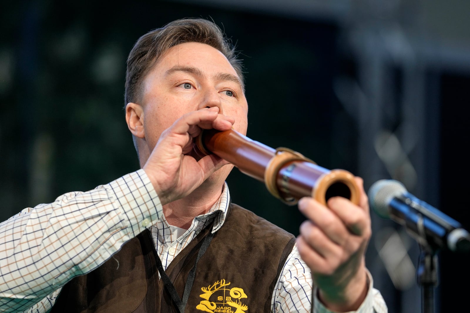 The winner Fabian Menzel performs to imitate a stag in heat during the German Championship of Deer-Calling at the hunting fair in Dortmund, Germany, Friday, Jan. 31, 2025. (AP Photo/Martin Meissner)