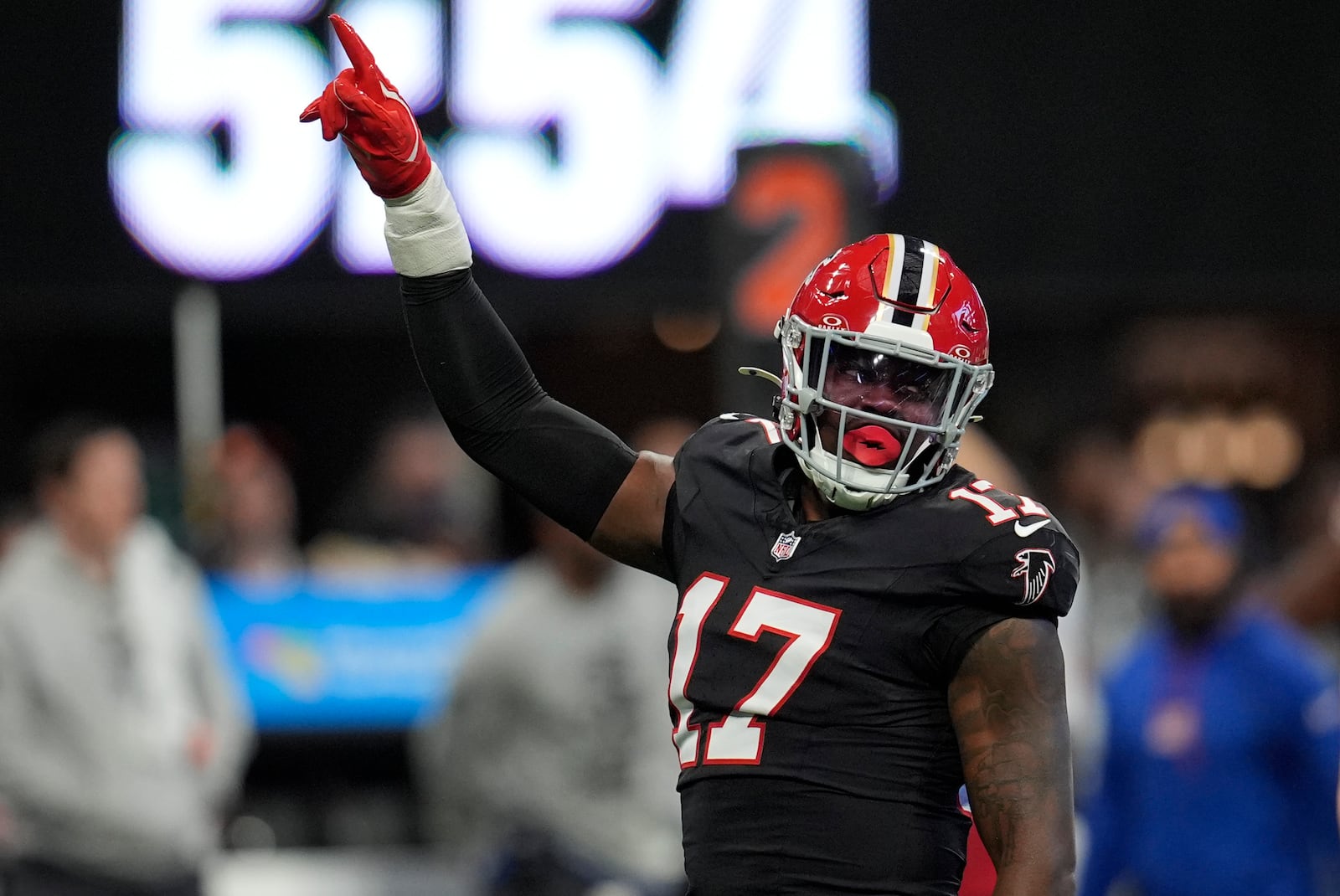 Atlanta Falcons linebacker Arnold Ebiketie (17) celebrates making a sack against New York Giants quarterback Drew Lock (2) in the first half of an NFL football game in Atlanta, Sunday, Dec. 22, 2024. (AP Photo/Mike Stewart)