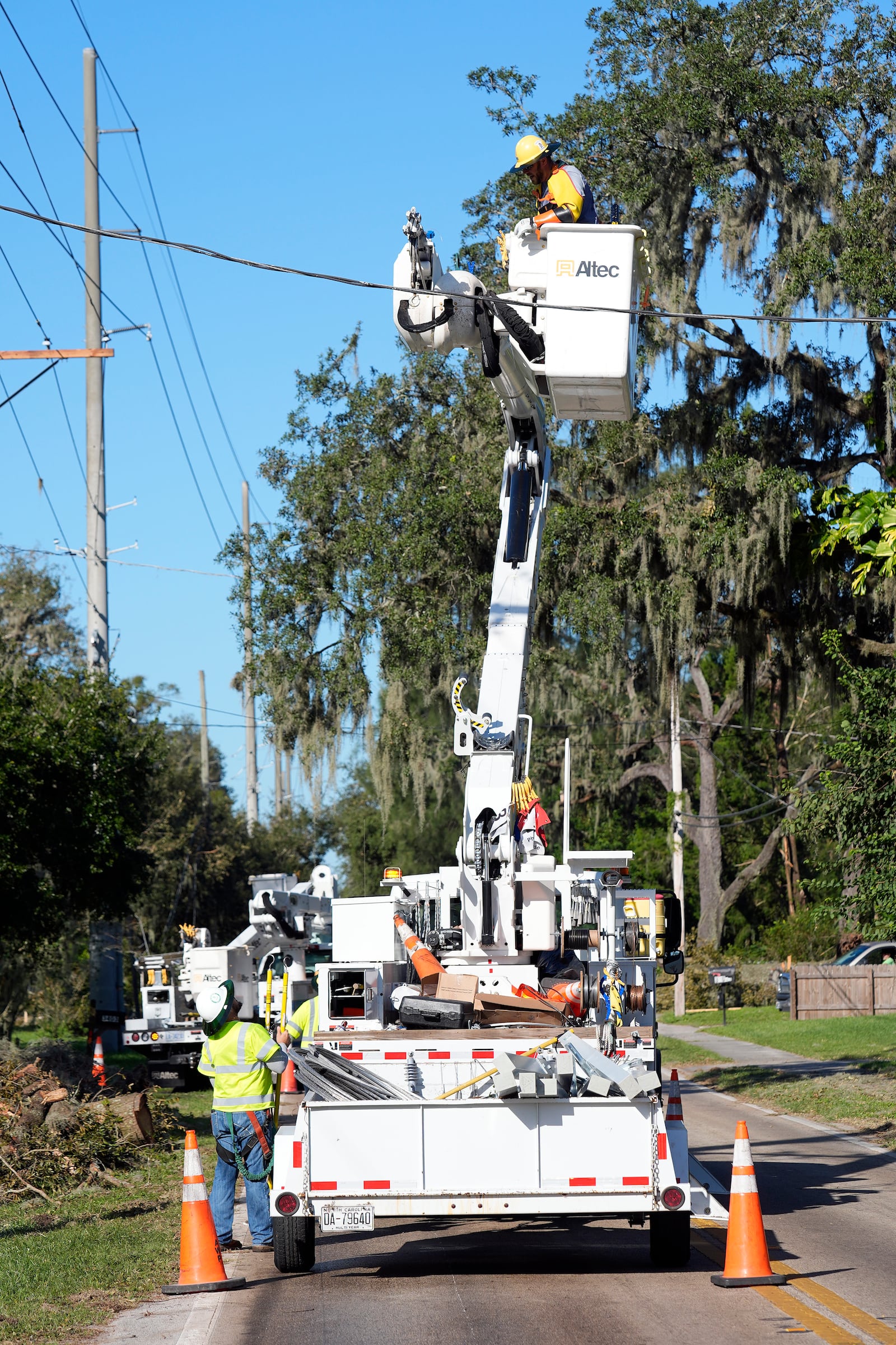 Pike Corporation, of North Carolina, linemen work to repair power lines damaged by Hurricane Milton, Sunday, Oct. 13, 2024, in Valrico, Fla. (AP Photo/Chris O'Meara)