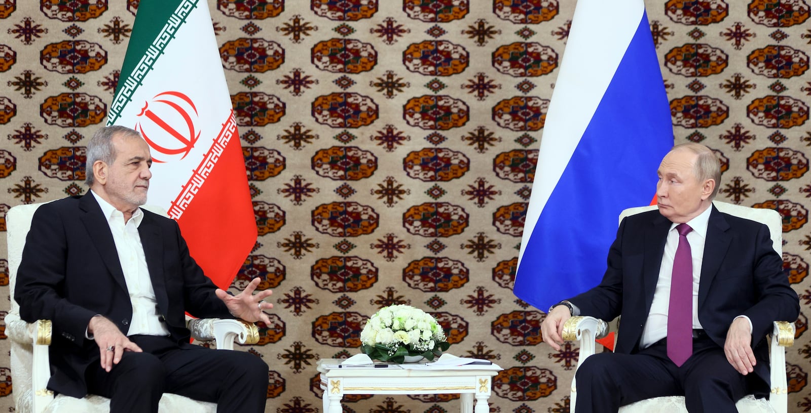 Russian President Vladimir Putin, right, listens to Iranian President Masoud Pezeshkian during their meeting on the sidelines of the International Forum "The Interconnection of Times and Civilizations – the basis of peace and development" dedicated to the 300th anniversary of the birth of the outstanding Turkmen poet and thinker Magtymguly Fragi in Ashgabat, Turkmenistan, Friday, Oct. 11, 2024. (Alexander Shcherbak, Sputnik, Kremlin Pool Photo via AP)