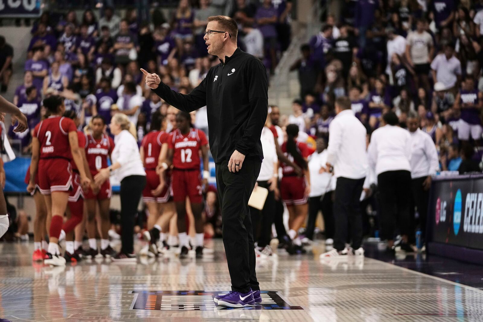 TCU head coach Mark Campbell instructs his team in the second half against Louisville in the second round of the NCAA college basketball tournament in Fort Worth, Texas, Sunday, March 23, 2025. (AP Photo/Tony Gutierrez)