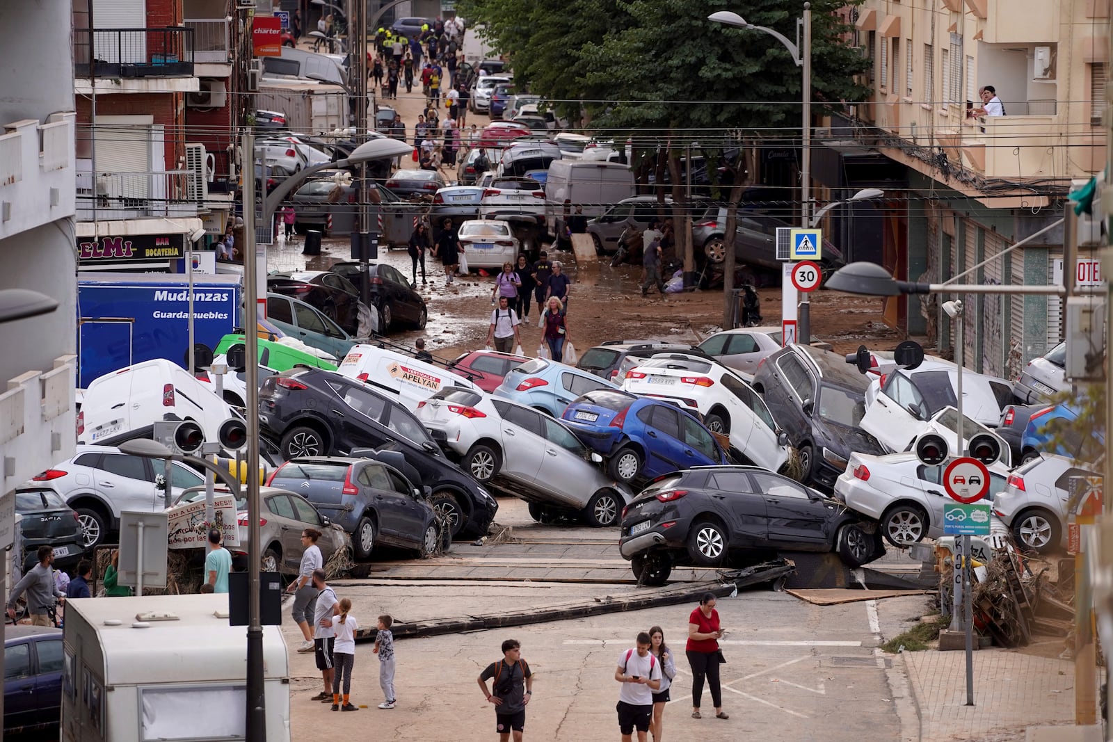 Vehicles are seen piled up after being swept away by floods in Valencia, Spain, Thursday, Oct. 31, 2024. (AP Photo/Alberto Saiz)