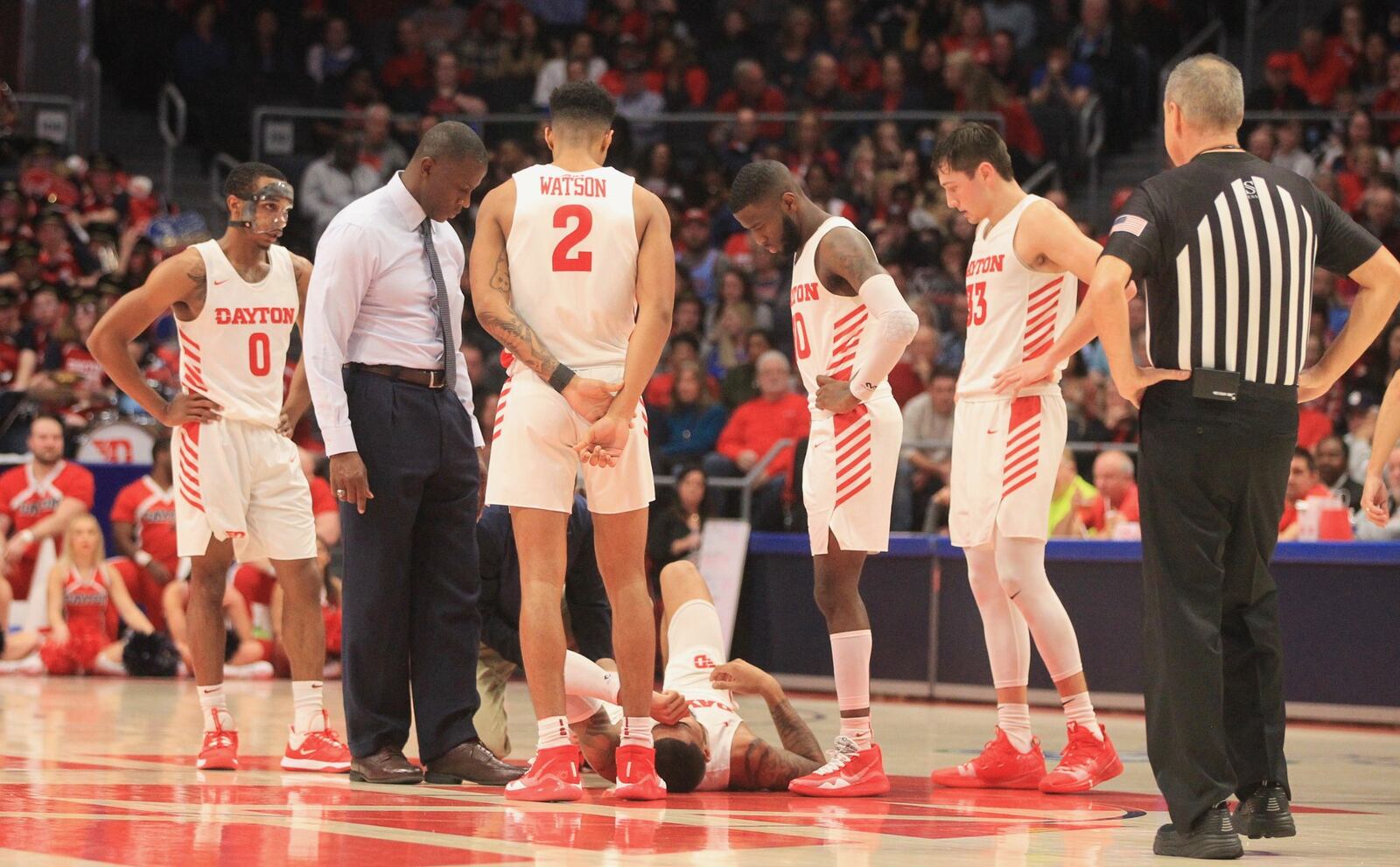 Dayton’s Obi Toppin lies on the floor after spraining his ankle in a game against Massachusetts on Saturday, Jan. 11, 2020, at UD Arena. David Jablonski/Staff