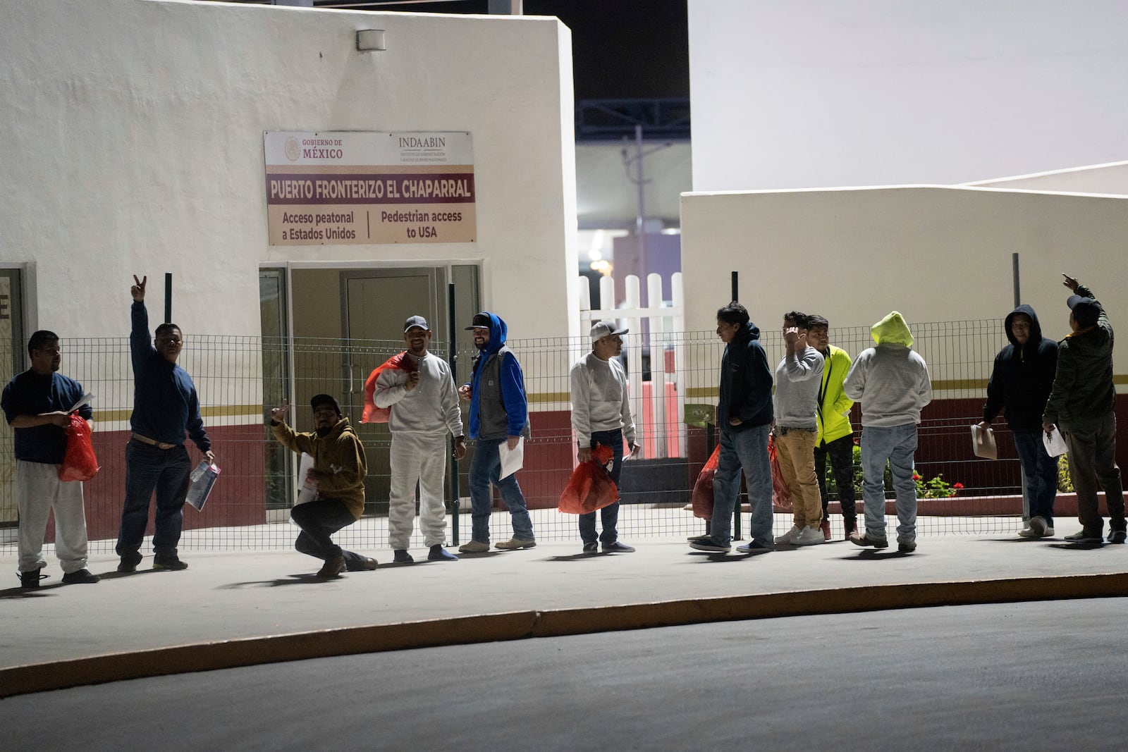 Migrants back into Mexico after being deported at El Chaparral pedestrian border bridge in Tijuana, Mexico, Tuesday, Jan. 21, 2025. (AP Photo/Felix Marquez)