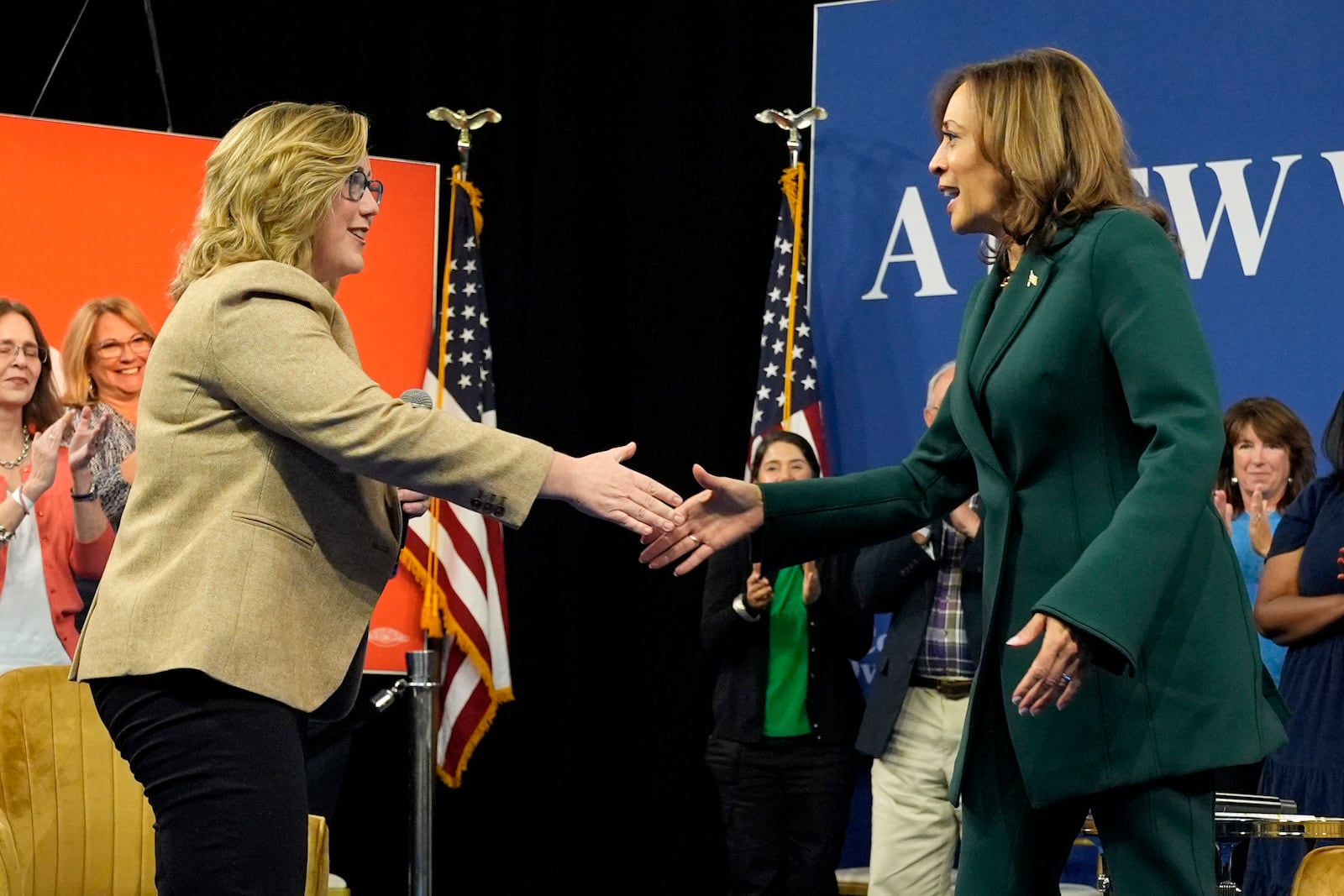 Democratic presidential nominee Vice President Kamala Harris, right, shakes hands with moderator Sarah Longwell, publisher of The Bulwark, at the conclusion of a town hall at The People's Light in Malvern, Pa., Monday, Oct. 21, 2024. (AP Photo/Jacquelyn Martin)