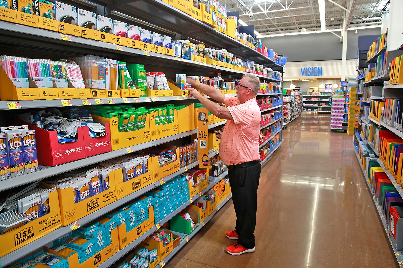 Harold Miller, the store manager at the Walmart on Bechtle Avenue in Springfield, straightens some of the school supplies in the store Friday, July 26, 2024. BILL LACKEY/STAFF