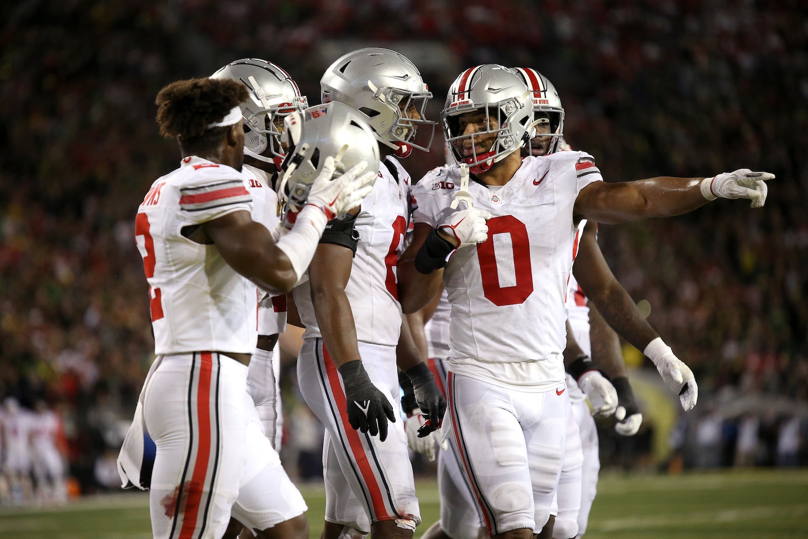 Members of the Ohio State defense speak during a break in play in an NCAA college football game against Oregon, Saturday, Oct. 12, 2024, in Eugene, Ore. (AP Photo/Lydia Ely)