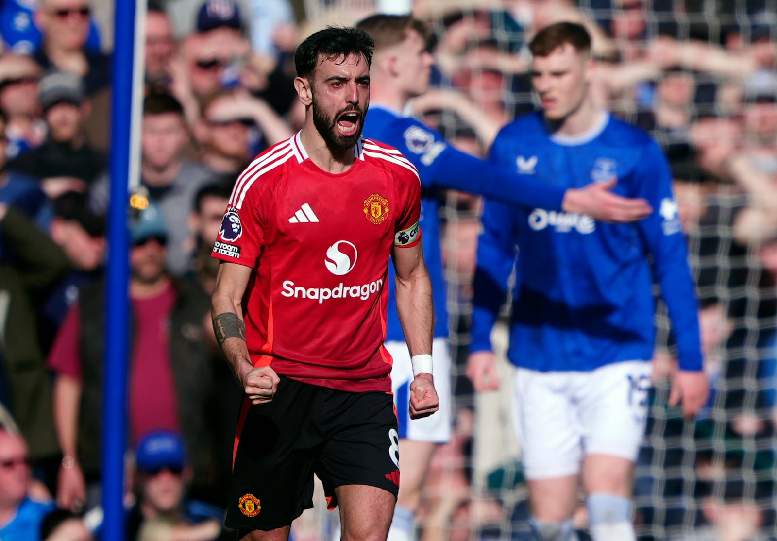 Manchester United's Bruno Fernandes celebrates scoring his side's first goal, during the English Premier League soccer match between Everton and Manchester United, at Goodison Park, in Liverpool, England, Saturday, Feb. 22, 2025. (Peter Byrne/PA via AP)