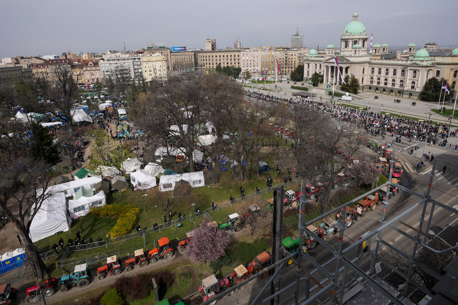 A view of students and former paramilitary fighters loyal to President Aleksandar Vucic camp outside the presidency building prior to a major anti-corruption rally in downtown Belgrade, Serbia, Saturday, March 15, 2025. (AP Photo/Darko Vojinovic)