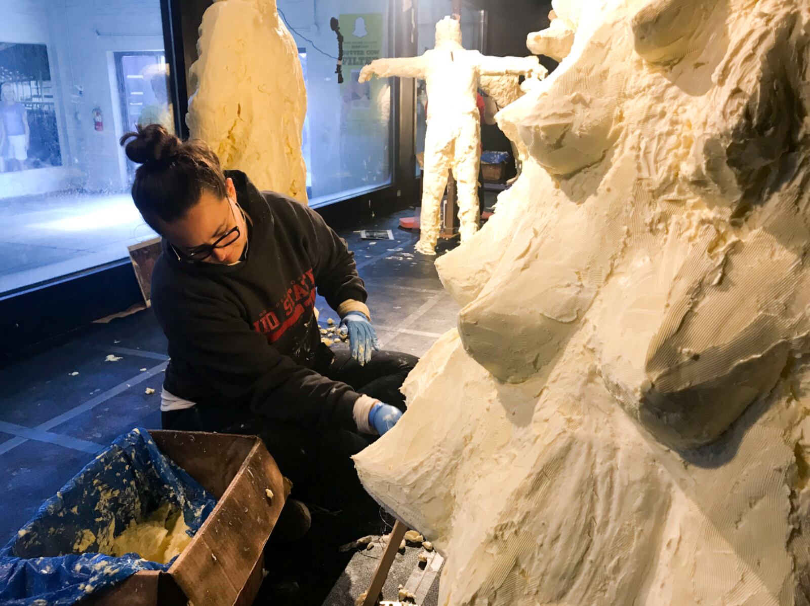 Erin Swearingen shapes the branches of the Christmas tree butter sculpture. After several hours of shaping and smoothing the butter, sculptors chisel in the fine details last. PHOTO: CONTRIBUTED