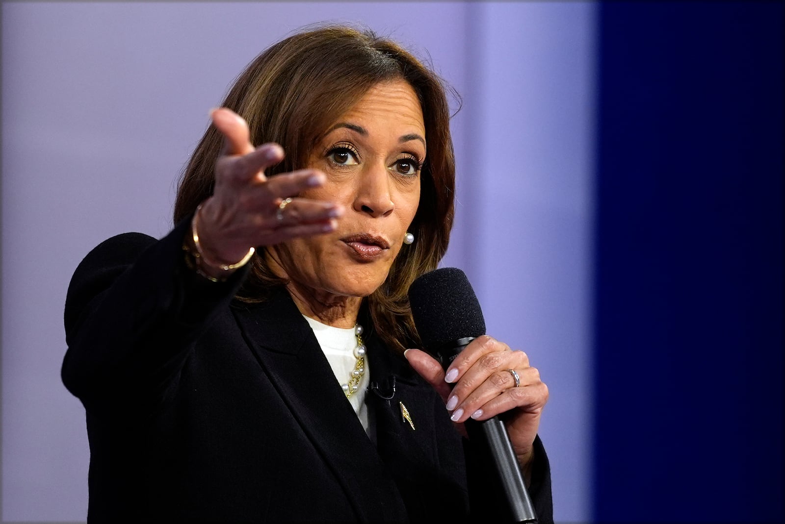 Democratic presidential nominee Vice President Kamala Harris speaks during a CNN town hall in Aston, Pa., Wednesday, Oct. 23, 2024, as moderator Anderson Cooper listens. (AP Photo/Matt Rourke)