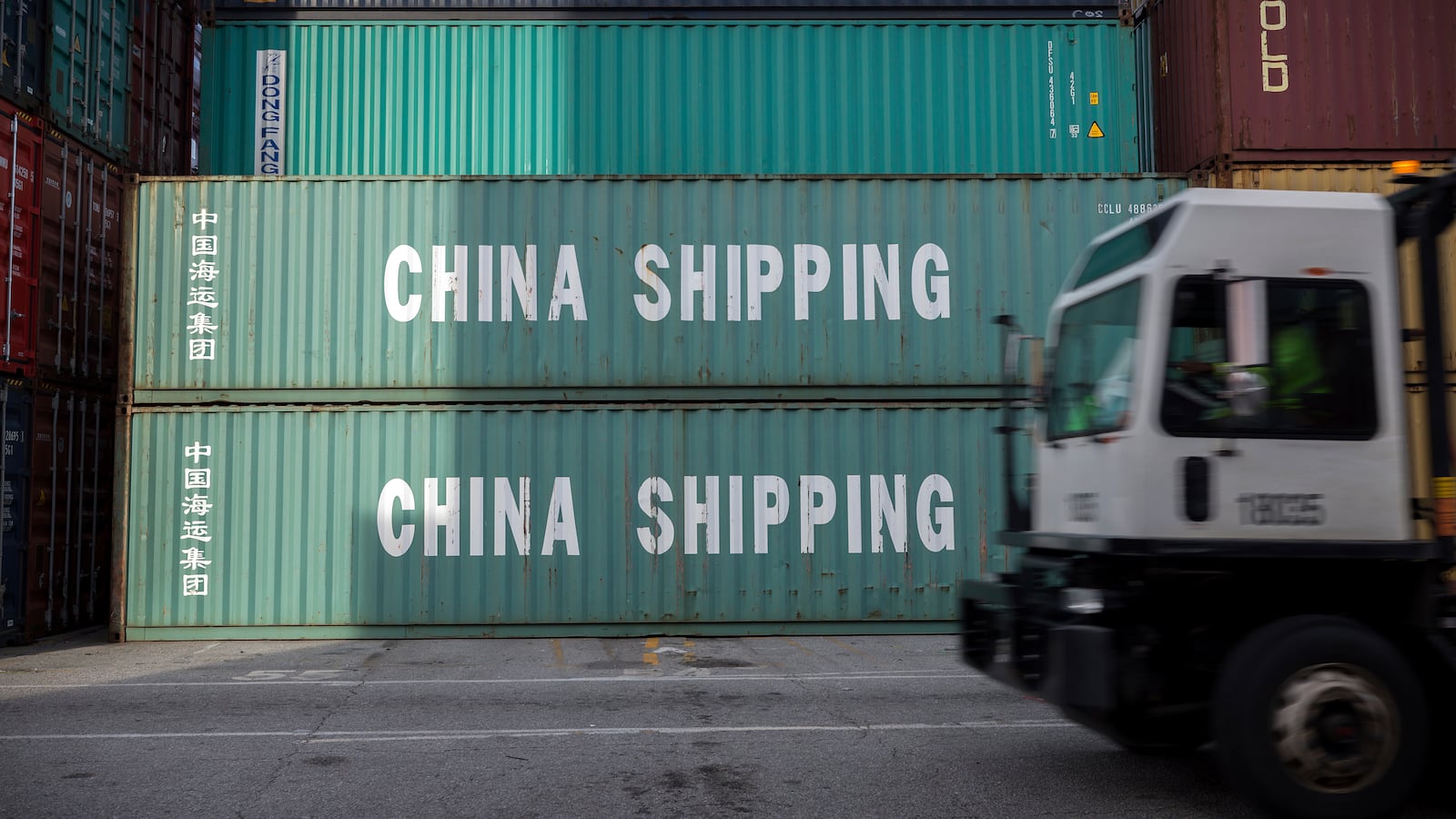 FILE - A jockey truck passes a stack of 40-foot China Shipping containers, July 5, 2018, at the Port of Savannah in Savannah, Ga. (AP Photo/Stephen B. Morton, File)