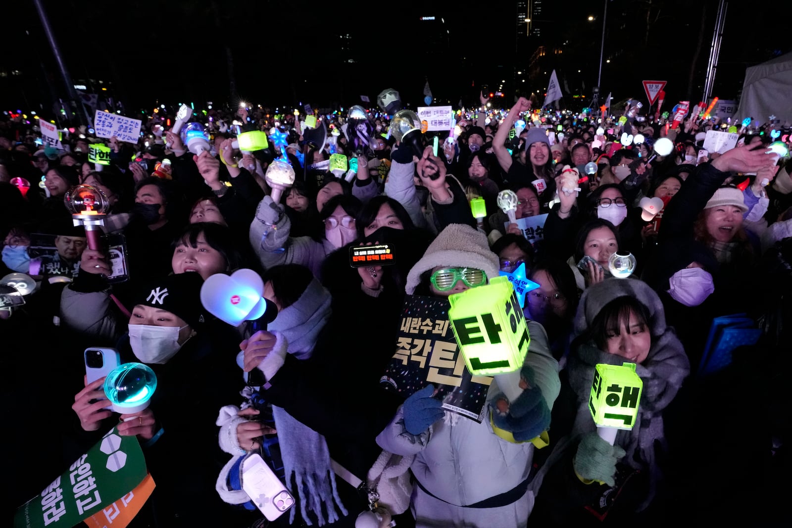 Participants gather to celebrate after South Korea's parliament voted to impeach President Yoon Suk Yeol outside the National Assembly in Seoul, South Korea, Saturday, Dec. 14, 2024. (AP Photo/Ahn Young-joon)