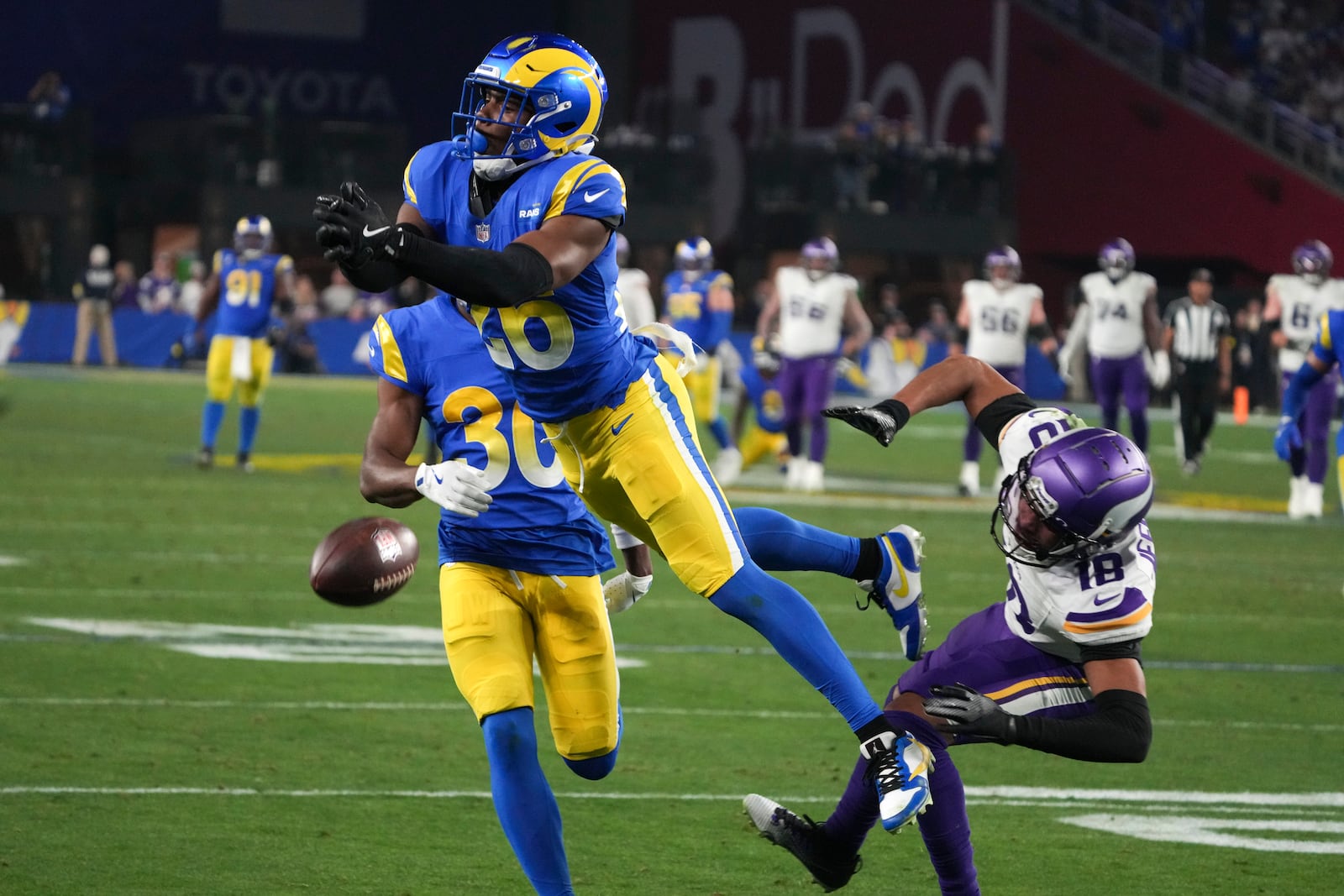 Los Angeles Rams safety Kamren Kinchens (26) defends a pass intended for Minnesota Vikings wide receiver Justin Jefferson (18) during the second half of an NFL wild card playoff football game, Monday, Jan. 13, 2025, in Glendale, Ariz. (AP Photo/Rick Scuteri)