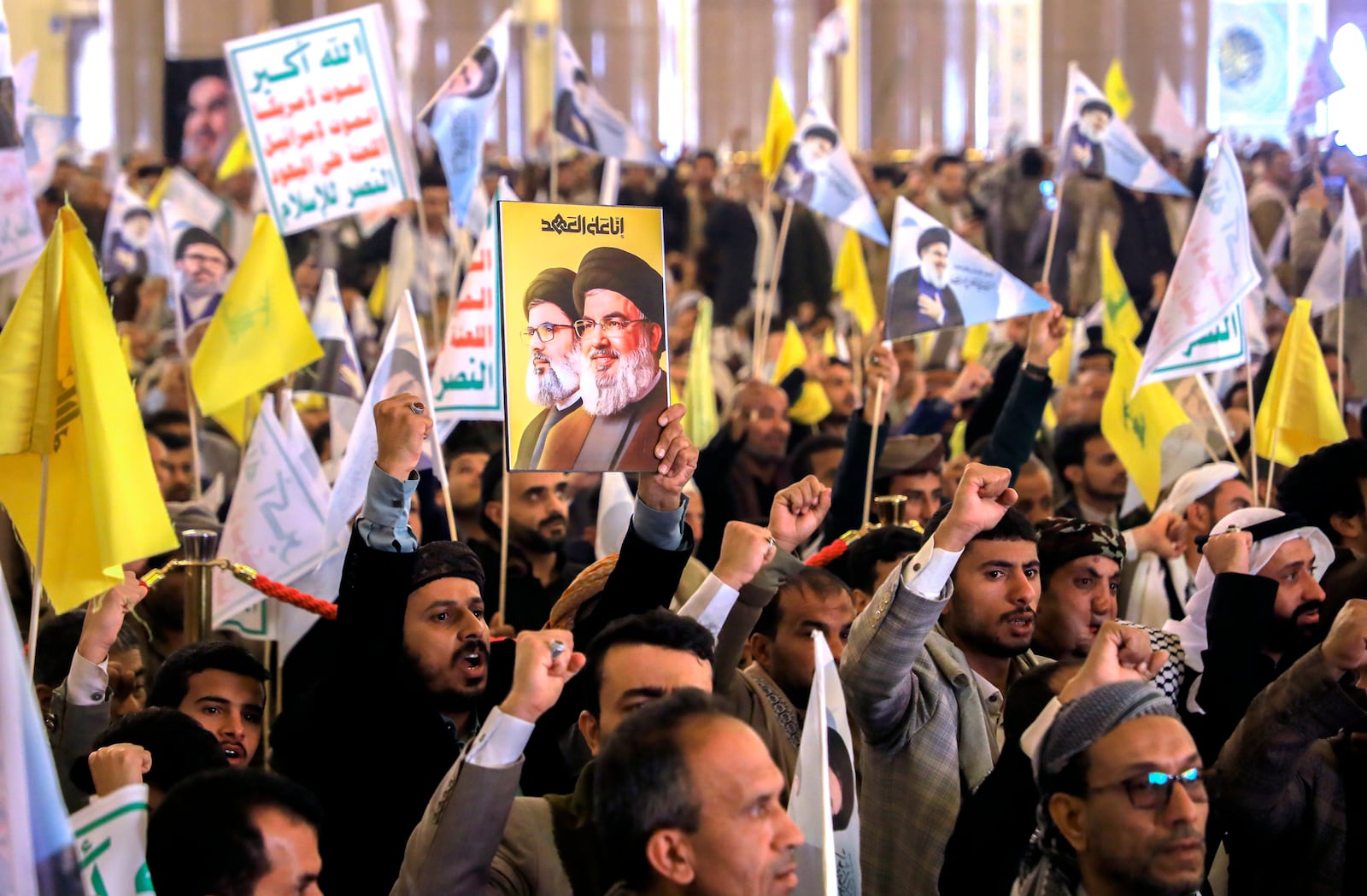 Houthi mourners hold pictures of Lebanon's former Hezbollah leaders, Hassan Nasrallah, during an absent funeral prayers in Sanaa, Yemen, Sunday Feb. 23, 2025. (AP Photo/Osamah Abdulrahman)