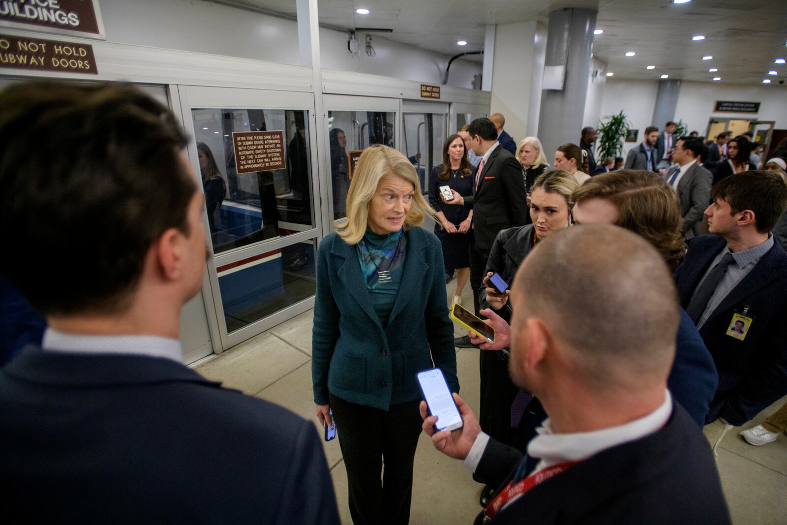 Sen. Lisa Murkowski, R-Alaska, talks with reporters as she makes her way through the Senate subway at the Capitol, Thursday, Jan. 23, 2025, in Washington. (AP Photo/Rod Lamkey, Jr.)