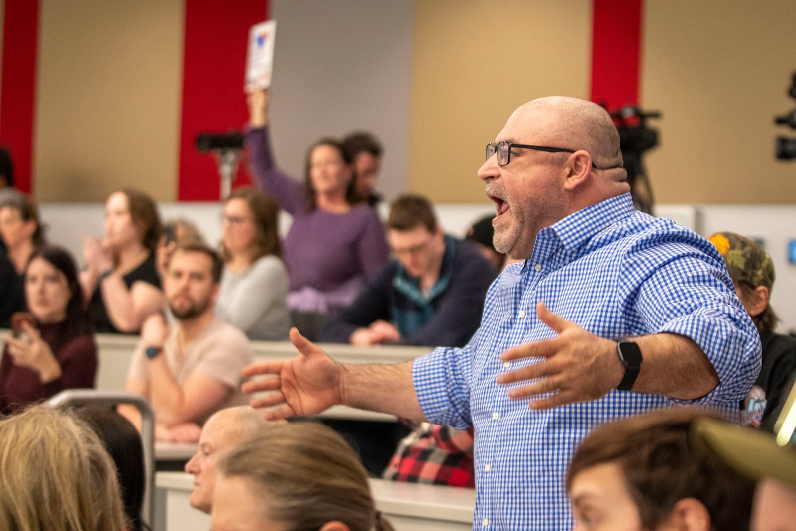 Michael Bretz raises his voice over the commotion to make a comment during a GOP town hall meeting with Reps. Celeste Maloy and Mike Kennedy, R-Utah, Thursday, March 20, 2025, in Salt Lake City. (AP Photo/Rick Egan)