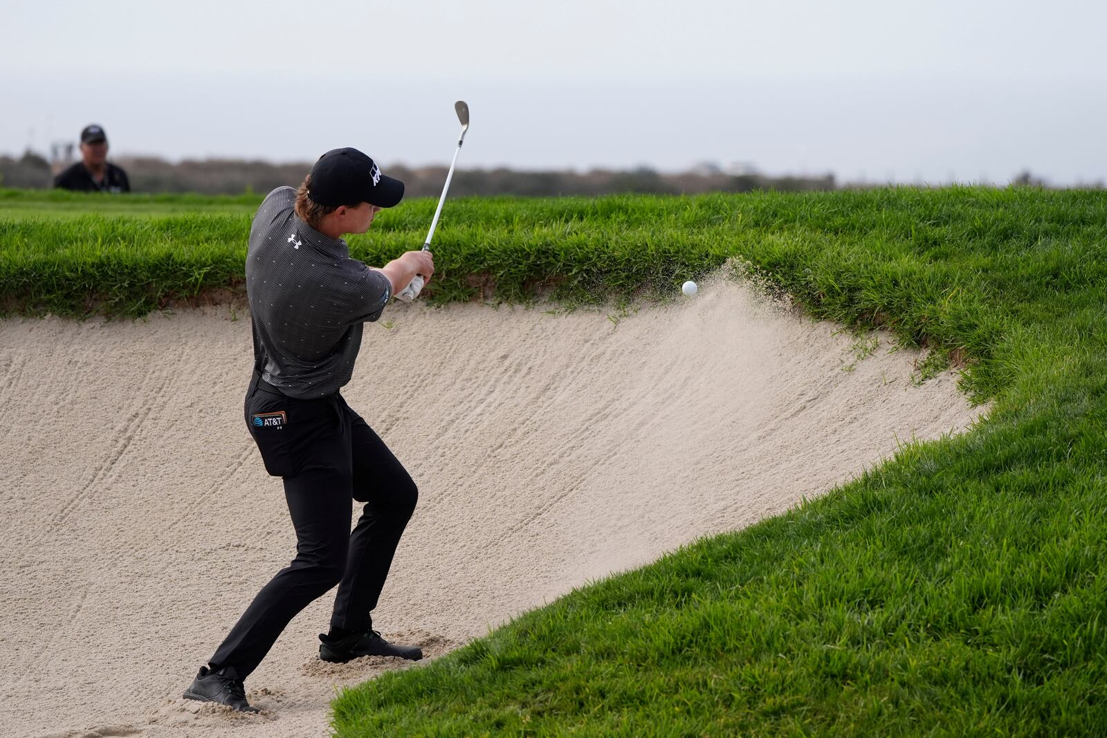 Maverick McNealy hits out of a bunker on the 14th hole of the South Course at Torrey Pines during the final round of the Genesis Invitational golf tournament Sunday, Feb. 16, 2025, in San Diego. (AP Photo/Gregory Bull)