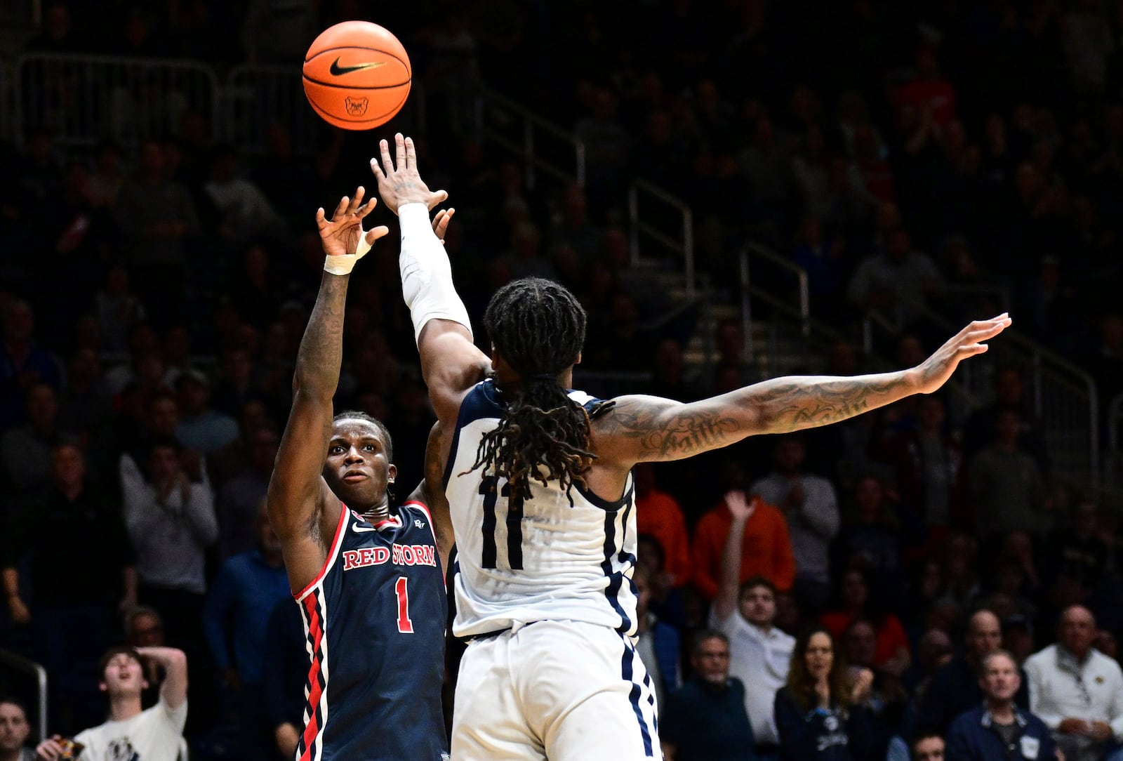 St. John's guard Kadary Richmond (1) shoots the ball over Butler forward Jahmyl Telfort (11) during the second half of an NCAA college basketball game, Wednesday, Feb. 26, 2025, in Indianapolis, Ind. (AP Photo/Marc Lebryk)